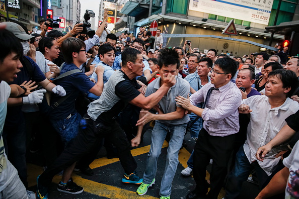 Hong Kong youth protesting against the Chinese government,  an angry crowd, mostly shopkeepers  who can not work and people paid by triads attacked a pro-democracy camp students in October 3, 2014 in Hong Kong (Canovas Alvaro—Paris Match via Getty Images)