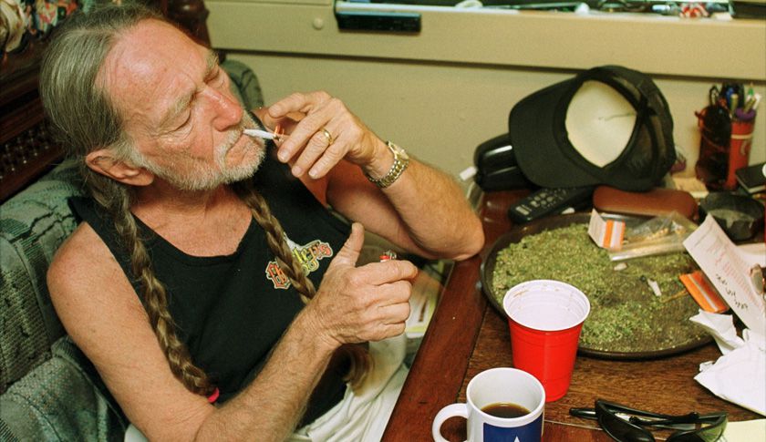 American country singer Willie Nelson takes a drag off a joint while relaxing at his home in Texas. (Hulton Archive&mdash;Getty Images)