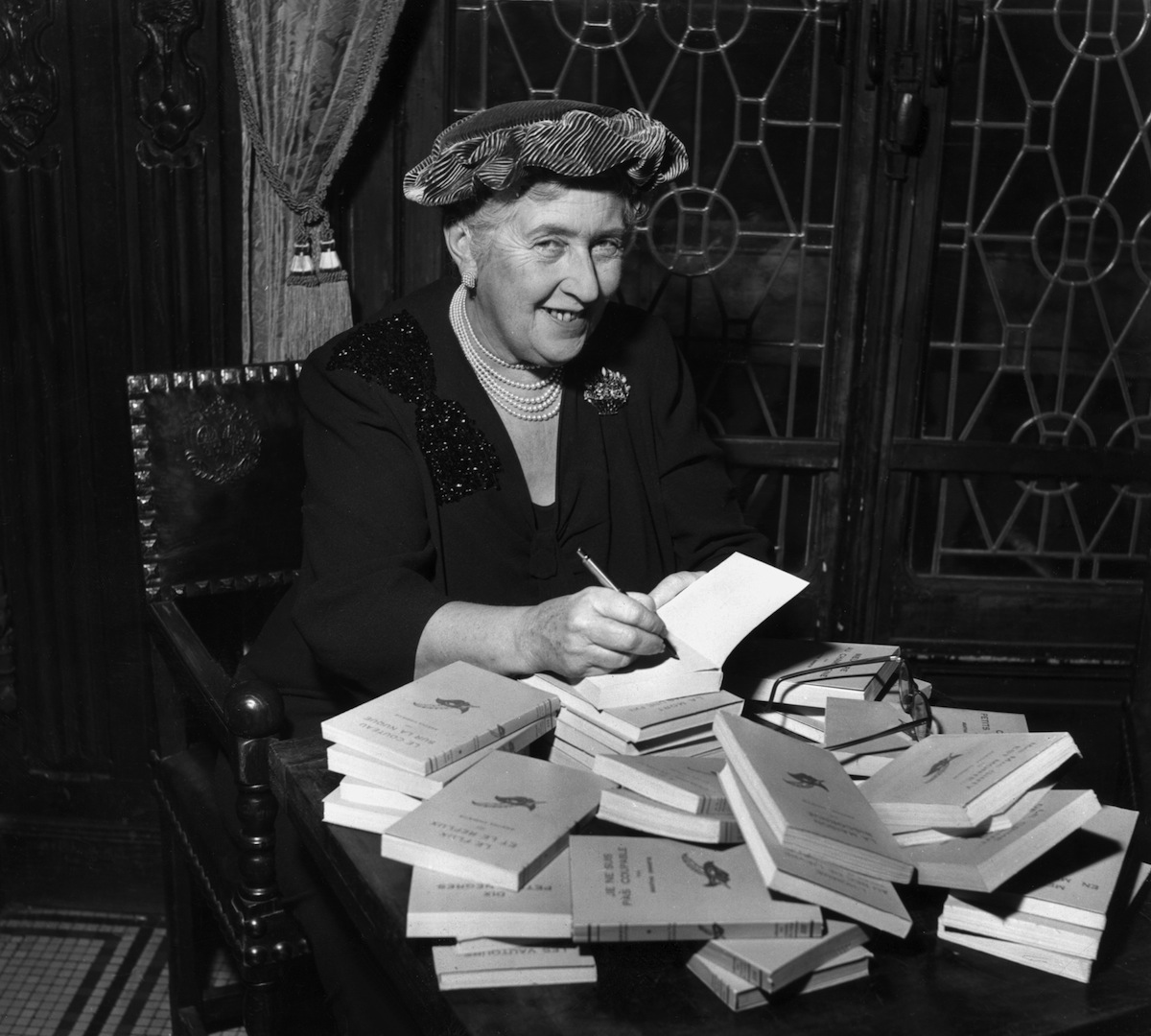 mystery author Agatha Christie (1890-1976) autographing French editions of her books in 1965 (Hulton Archive / Getty Images)