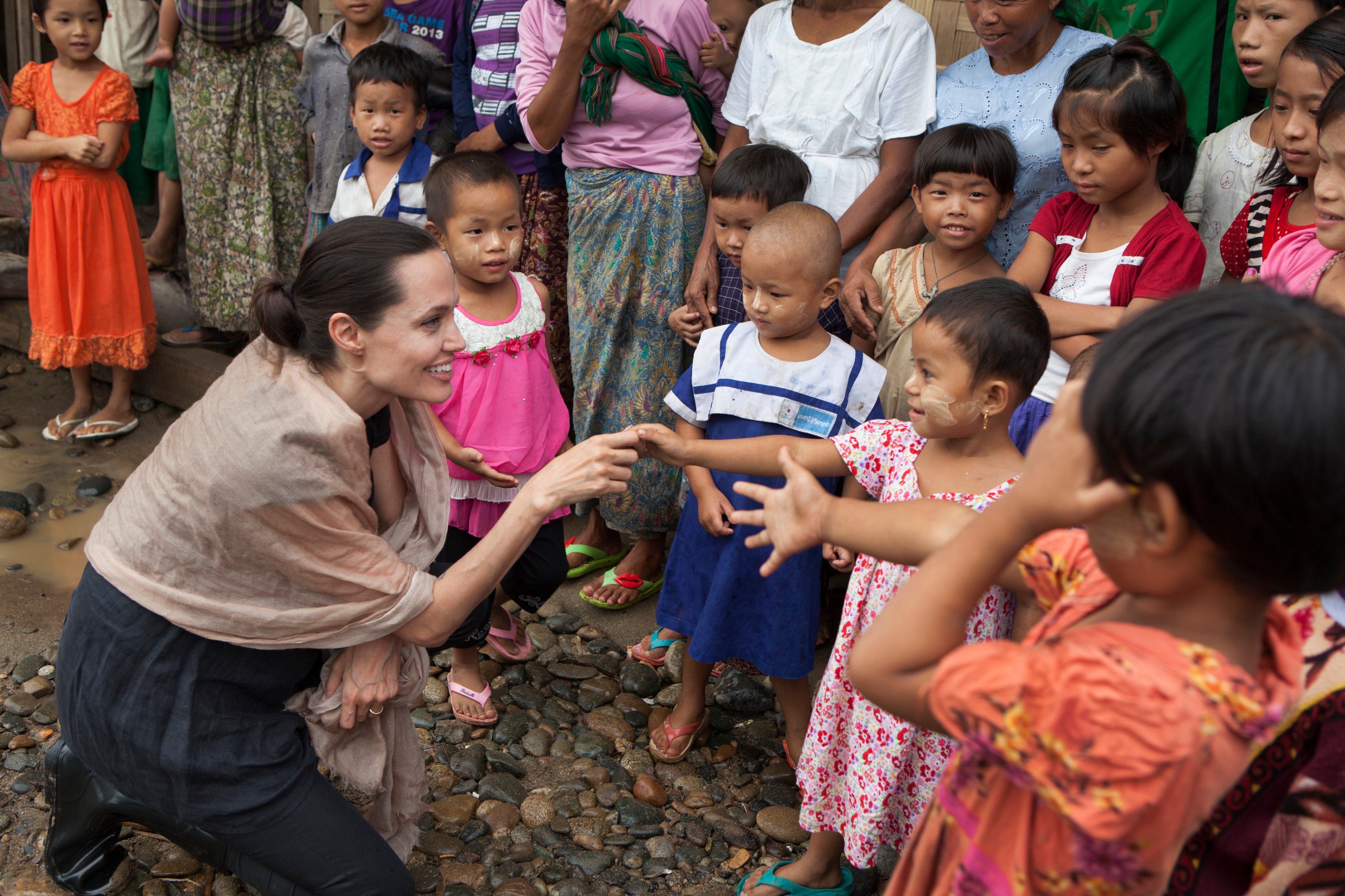 In this handout photo provided by the Maddox Jolie-Pitt Foundation, actress and activist Angelina Jolie Pitt meets children during a visit to Ja Mai Kaung Baptist refugee camp on July 30, 2015 in Myitkyina, Burna.