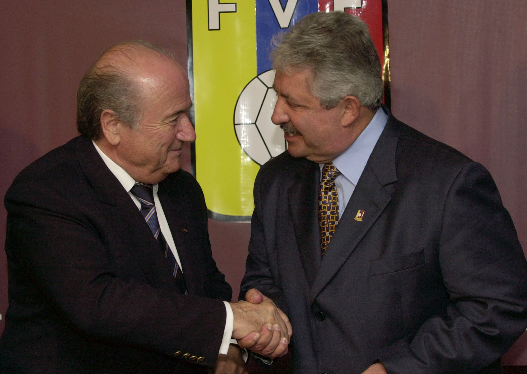 Joseph Blatter, President of the FIFA, left, shakes hands with the President of the Venezuelan Soccer Federation, Rafael Esquivel, in Caracas, Venezuela, Nov. 8, 2004 (Leslie Mazoch—AP)