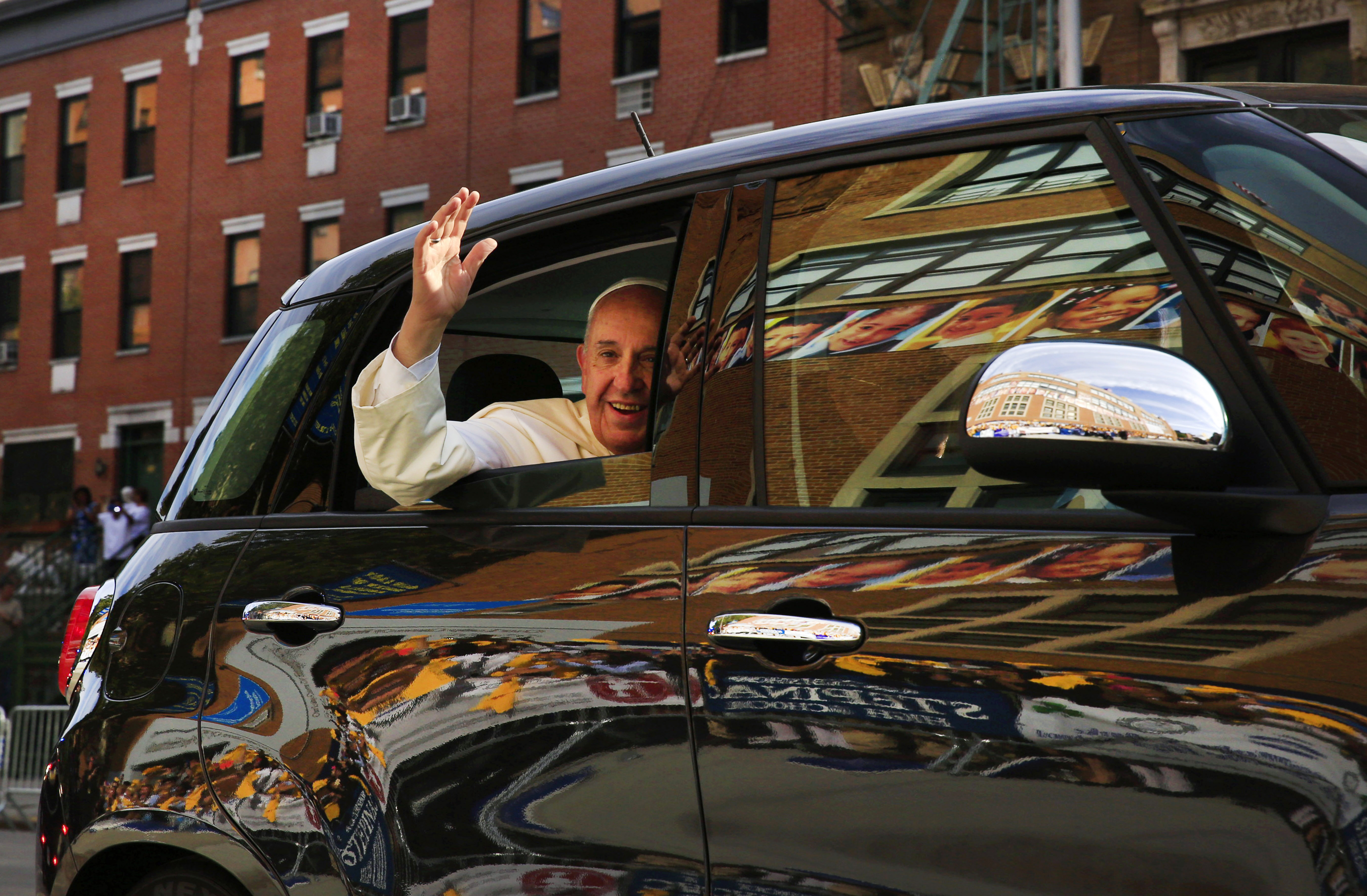 Pope Francis arrives in his car for a visit to Our Lady Queen of Angels School in the Harlem neighborhood of New York, on Sept. 25, 2015.