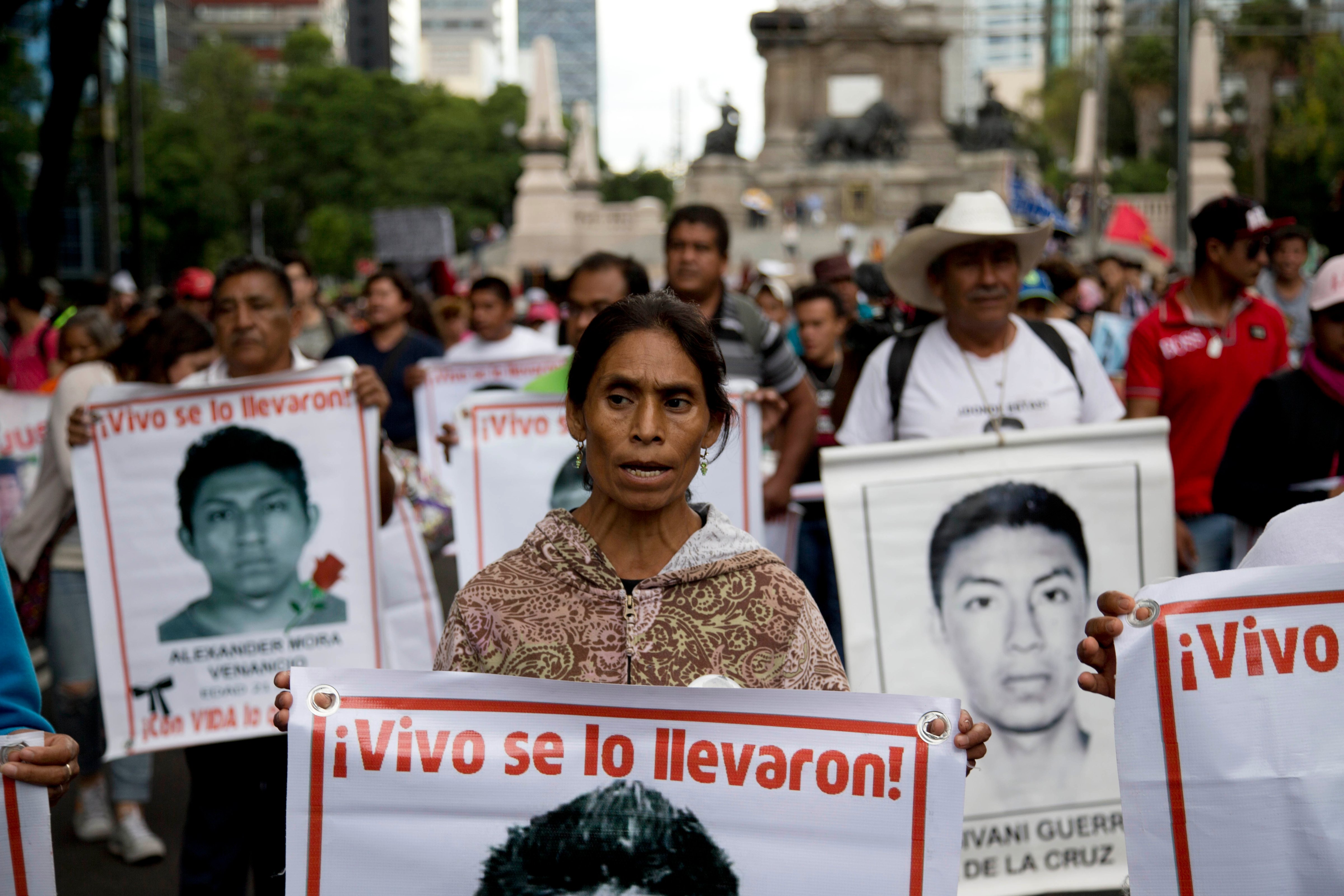 Relatives and protestors carry banners with pictures of some of the 43 missing students from a rural teachers college, during a march in Mexico City, Aug. 26, 2015 (Eduardo Verdugo—AP)