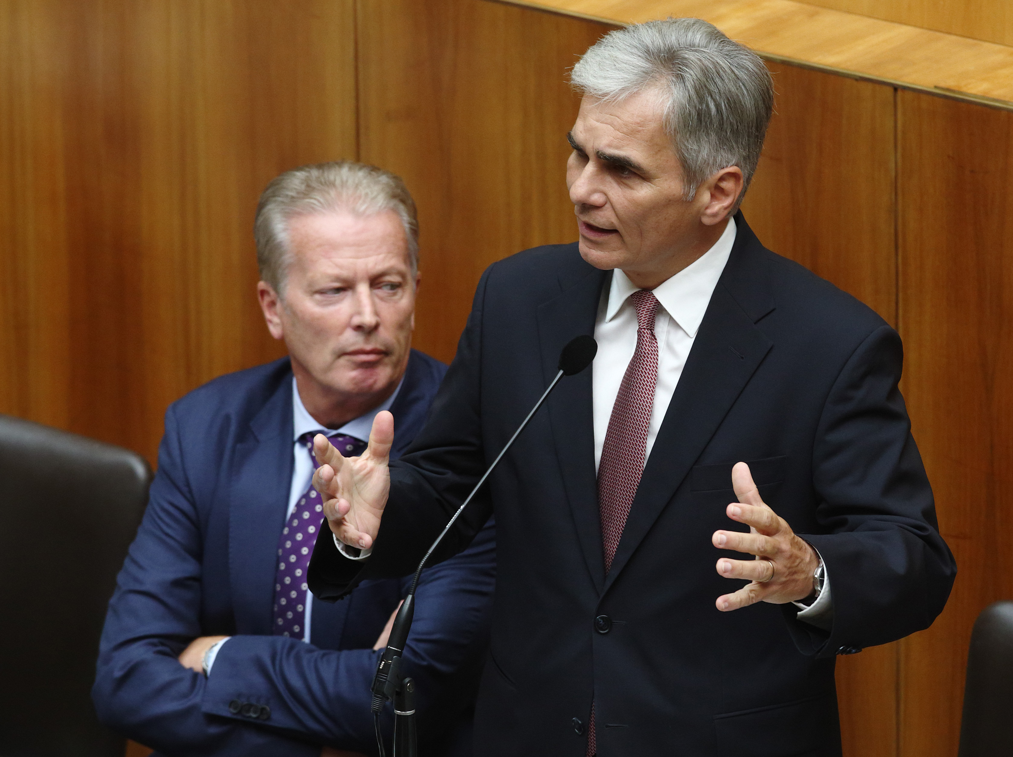 Austrian Chancellor Werner Faymann (R) talks next to Vice Chancellor Reinhold Mitterlehner during an extraordinary session of the parliament on migration policy in Vienna on Sept. 1, 2015. (Heinz-Peter Bader—Reuters)