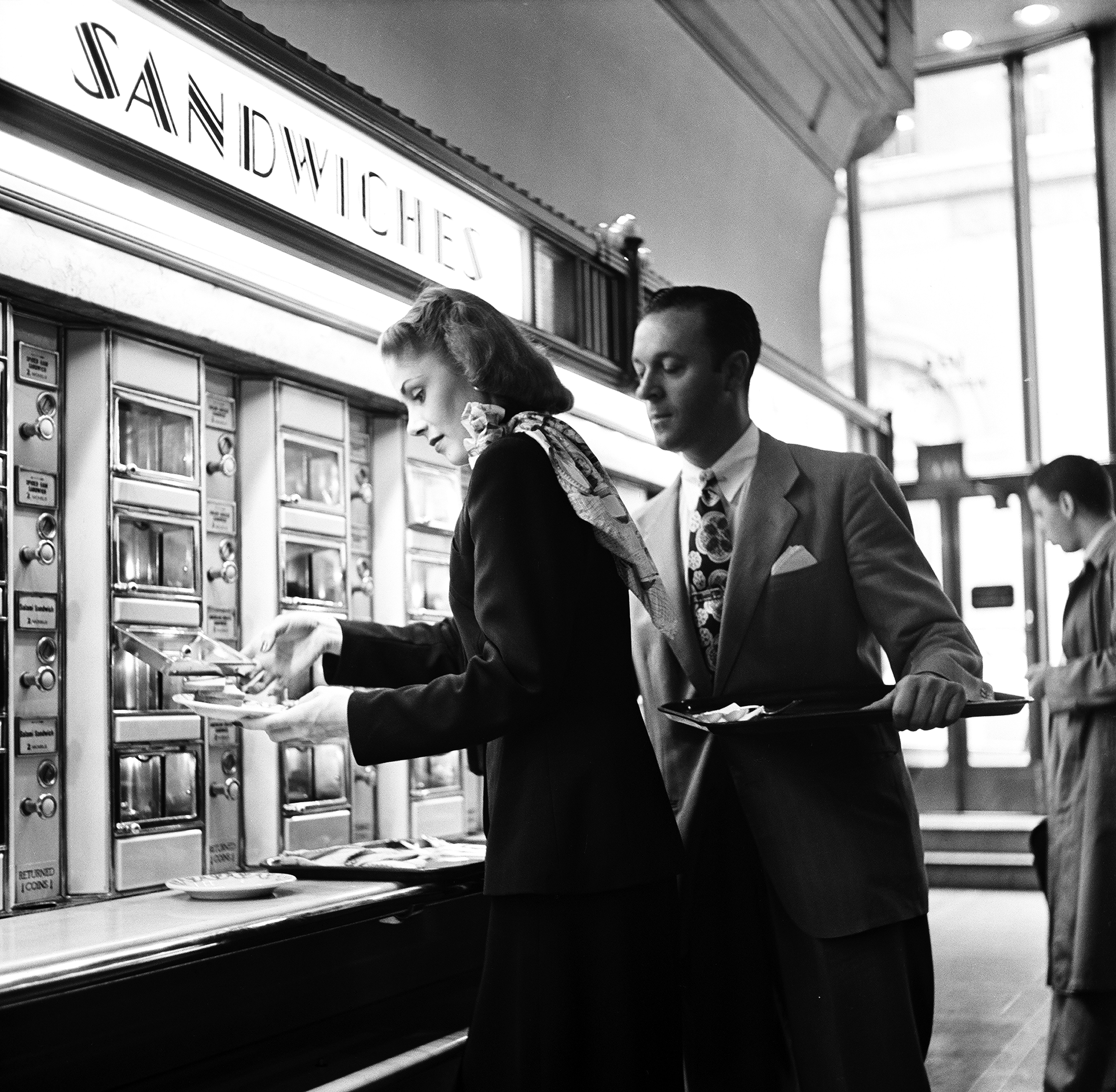 View of a well-dressed man and woman deciding on sandwiches at Grand Central Station automat in New York, 1948. (Rae Russel—Getty Images)