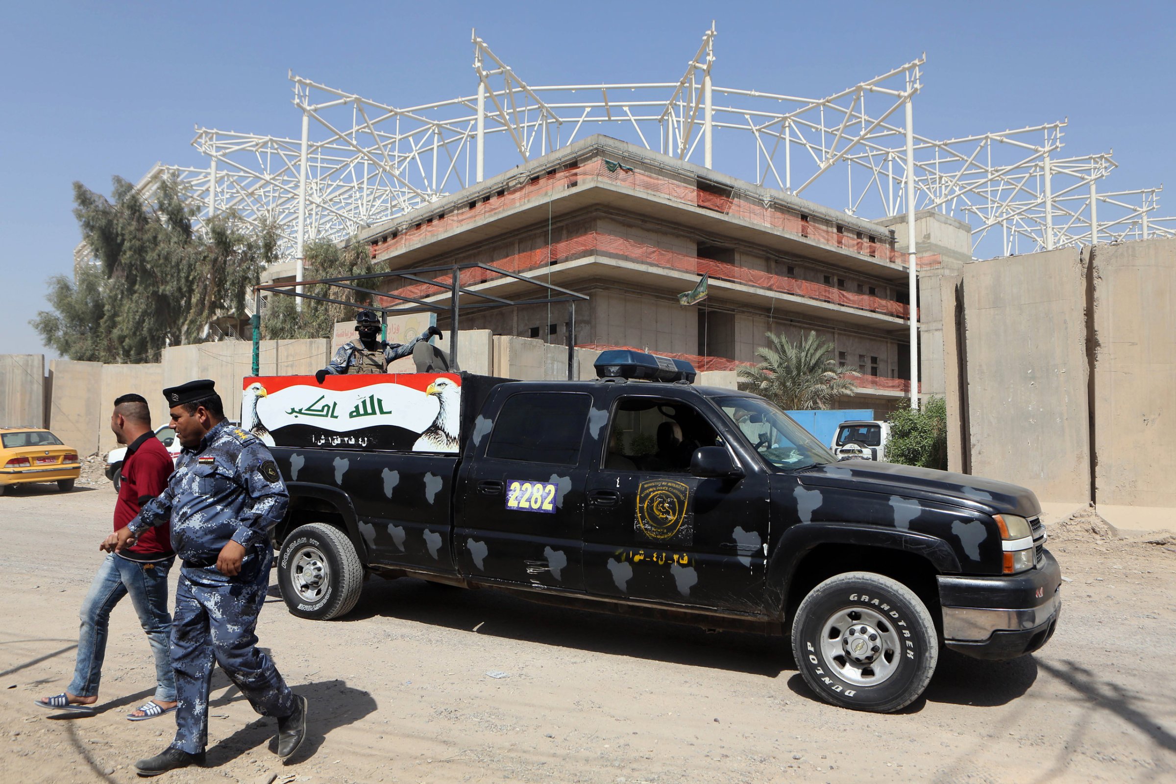 Iraqi security forces guard the entrance to a sports complex being built by a Turkish construction company, in the Shiite district of Sadr City, Baghdad, Iraq, Wednesday, Sept. 2, 2015. Masked men in military uniforms kidnapped 18 Turkish workers and engineers working at the site in Baghdad at dawn Wednesday, bundling them into several SUVs and speeding away, Iraqis security officials said. (AP Photo/Khalid Mohammed)