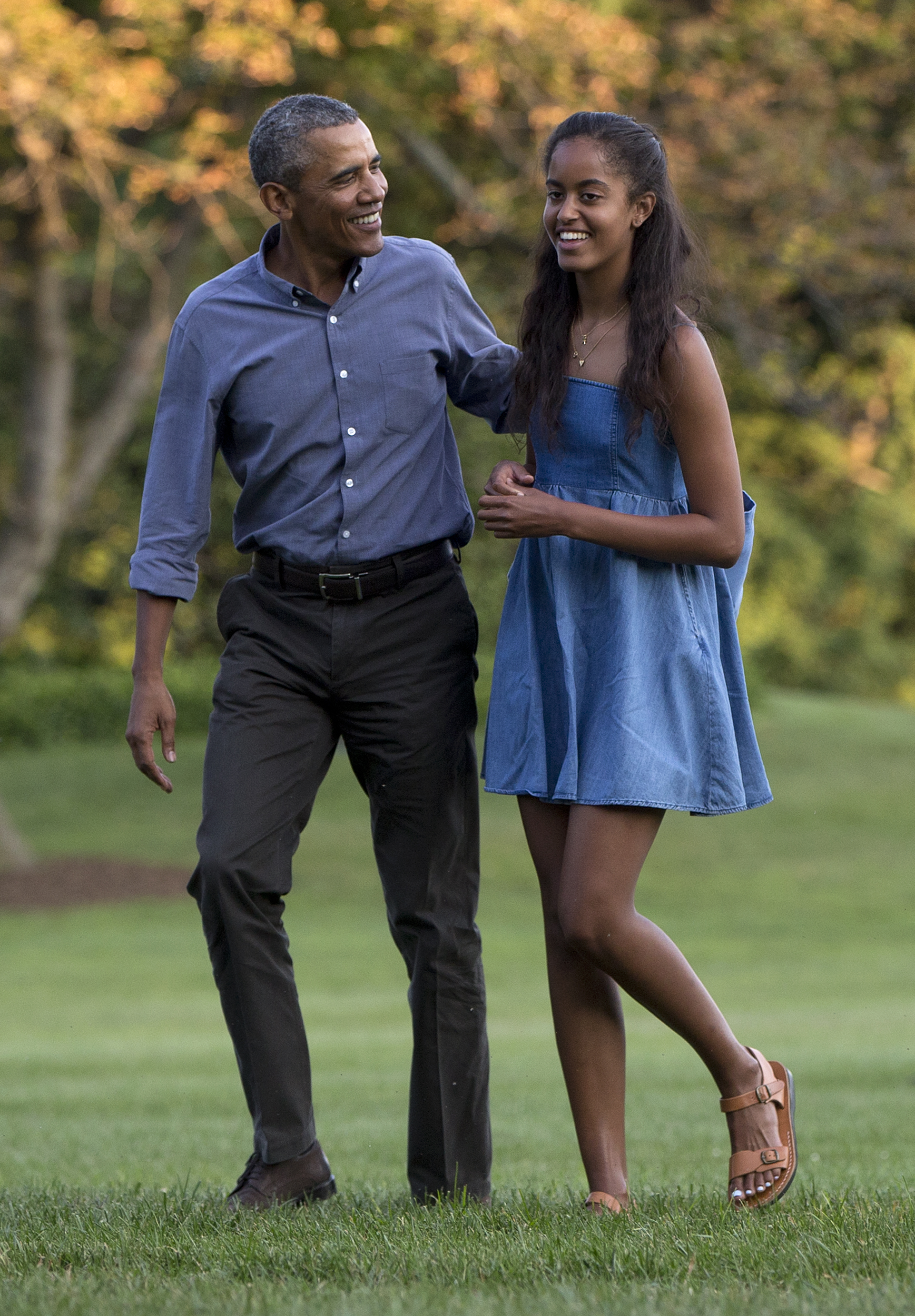 President Barack Obama and his daughter Malia walk across the South Lawn of the White House in Washington on Aug. 23, 2015.