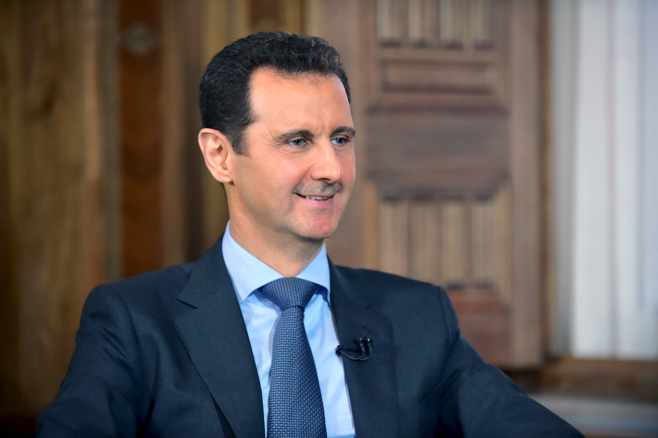Syria's President Bashar al-Assad answers questions during an interview with al-Manar's journalist Amro Nassef on Aug. 25, 2015 in Damascus, Syria. (Sana Sana—Reuters)