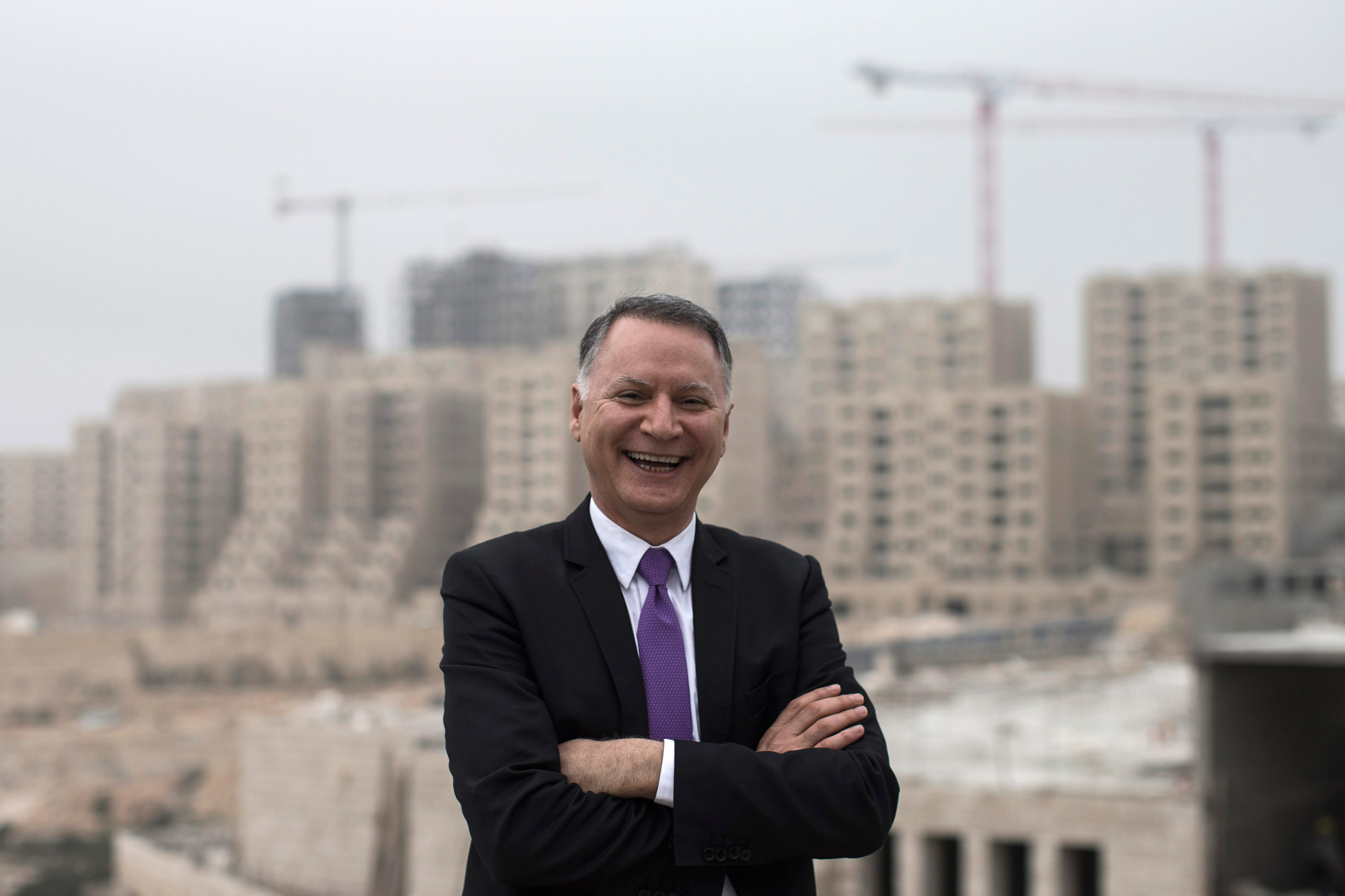 Bashar Masri, main investor of the new Palestinian city of Rawabi, in front of an apartment building under construction in Rawabi, West Bank, on Feb. 24, 2014. (Oliver Weiken—EPA/Corbis)