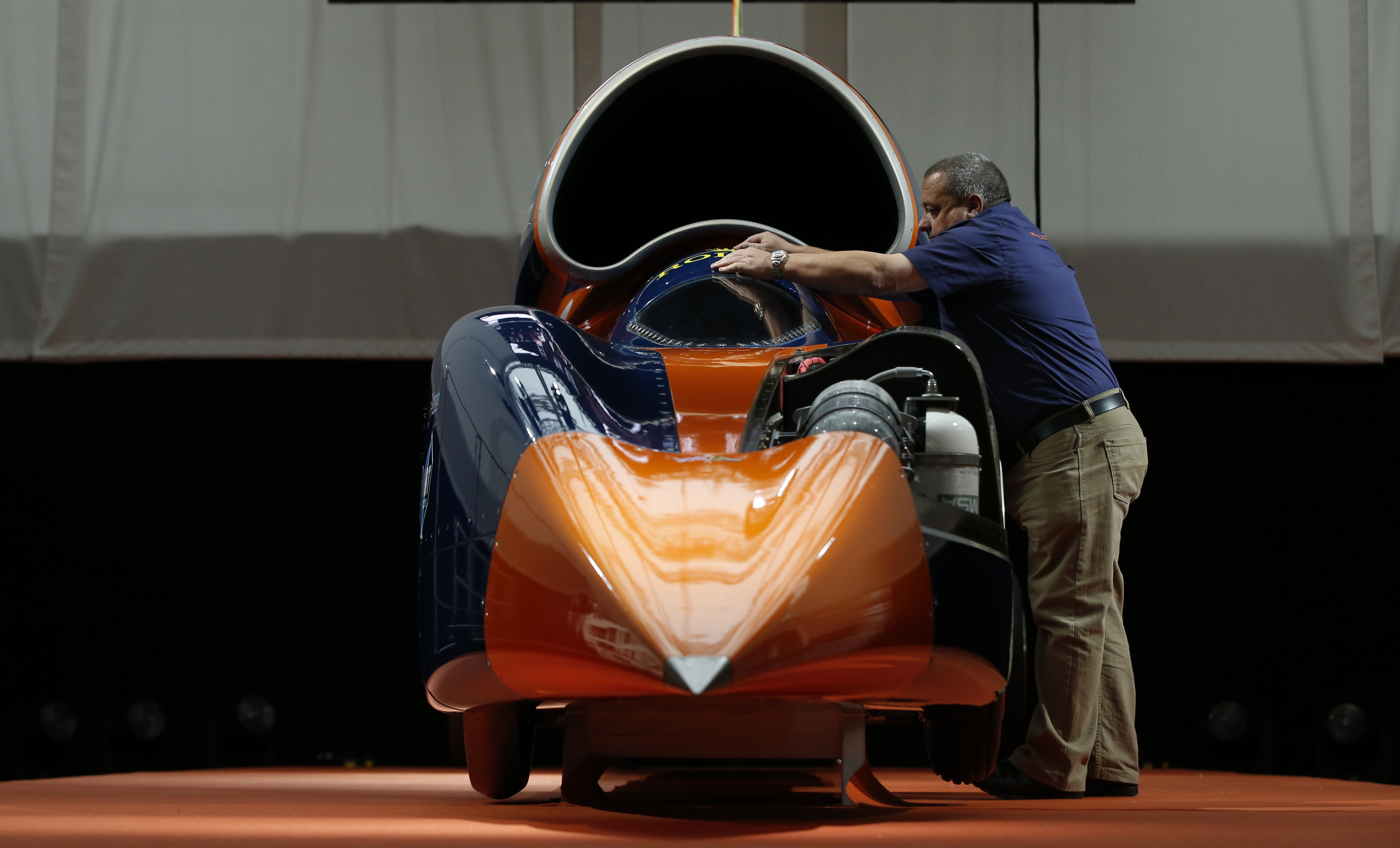 A technician places the cockpit cover on the British backed Bloodhound SSC streamliner car in London on Thursday, Sept. 24, 2015 (Alastair Grant&mdash;AP)