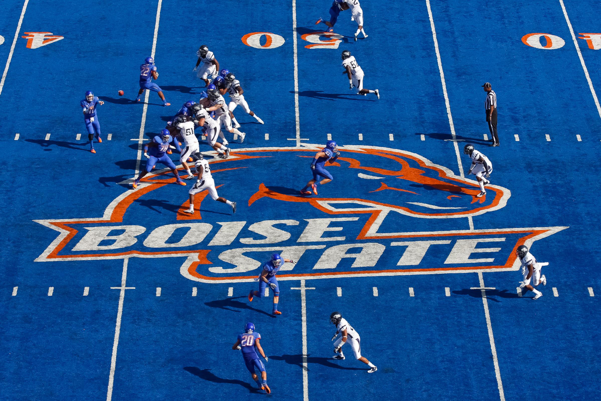 Kellen Moore #11 of the Boise State Broncos (L) passes against the Nevada Wolf Pack at Bronco Stadium in Boise, Idaho on Oct. 1, 2011.