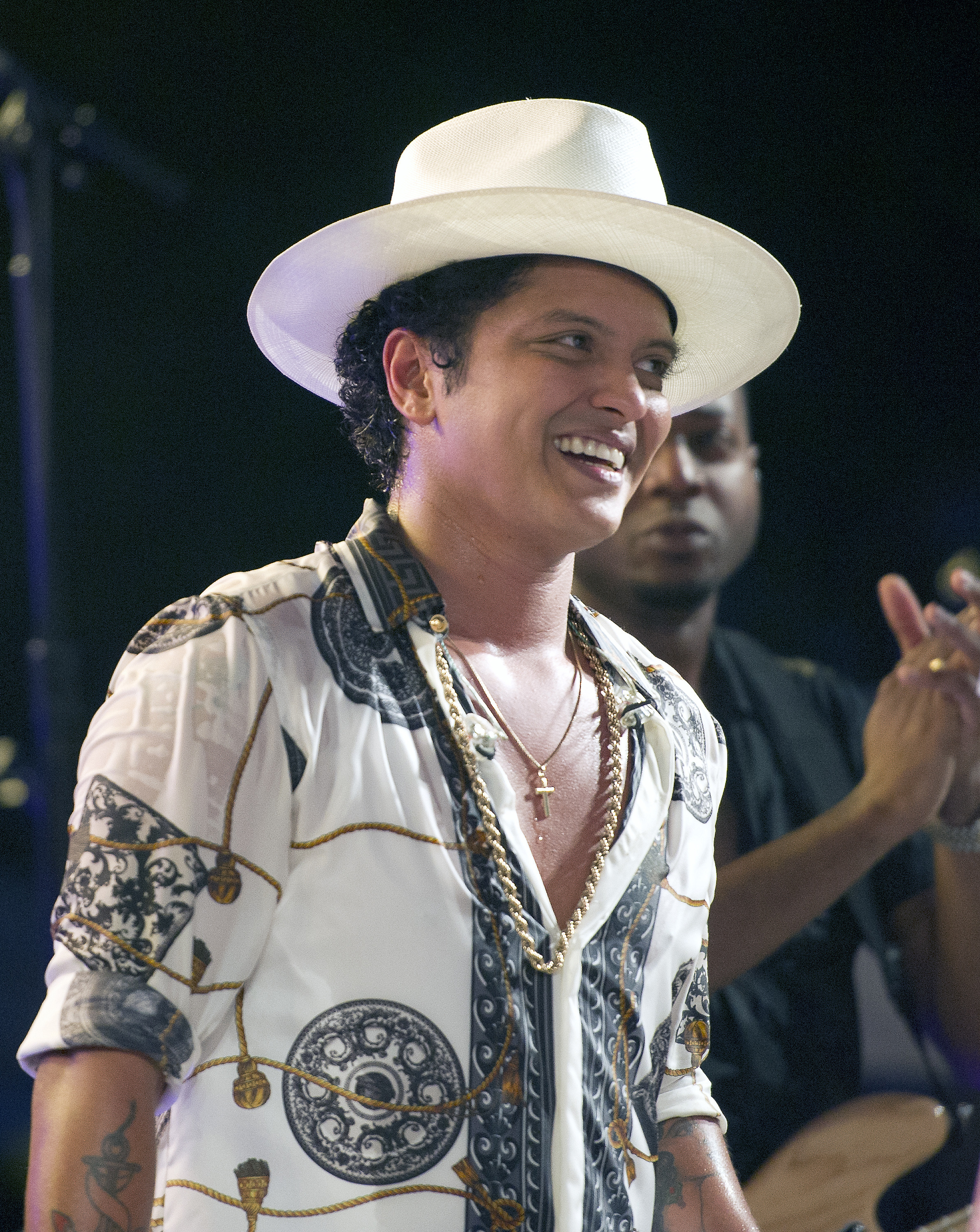 Bruno Mars smiles as President Obama makes remarks to members of the military and White House staff who were invited to the South Lawn of the White House in Washington, DC on July 4, 2015. (Ron Sachs—AP)