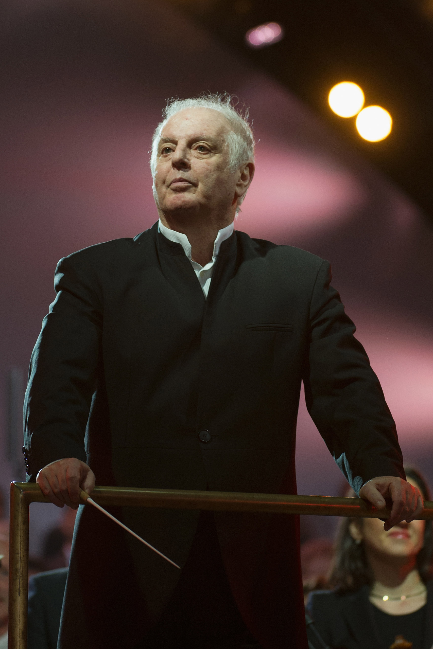 BERLIN, GERMANY - NOVEMBER 09: Conductor Daniel Barenboim performs at Brandenburg Gate during celebrations on the 25th anniversary of the fall of Wall on November 9, 2014 in Berlin, Germany. The city of Berlin is is commemorating the 25th anniversary of the fall of the Berlin Wall with an installation of 6,800 lamps coupled with illuminated balloons along a 15km route where the Wall once ran and divided the city into capitalist West and communist East. The fall of the Wall on November the 9, 1989 was among the most powerful symbols of the revolutions that swept through the communist countries of Eastern Europe and heralded the end of the Cold War. Built by the communist authorities of East Germany in 1961, the Wall prevented East Germans from fleeing west and was equipped with guard towers and deadly traps. (Photo by Target Presse Agentur Gmbh/Getty Images)