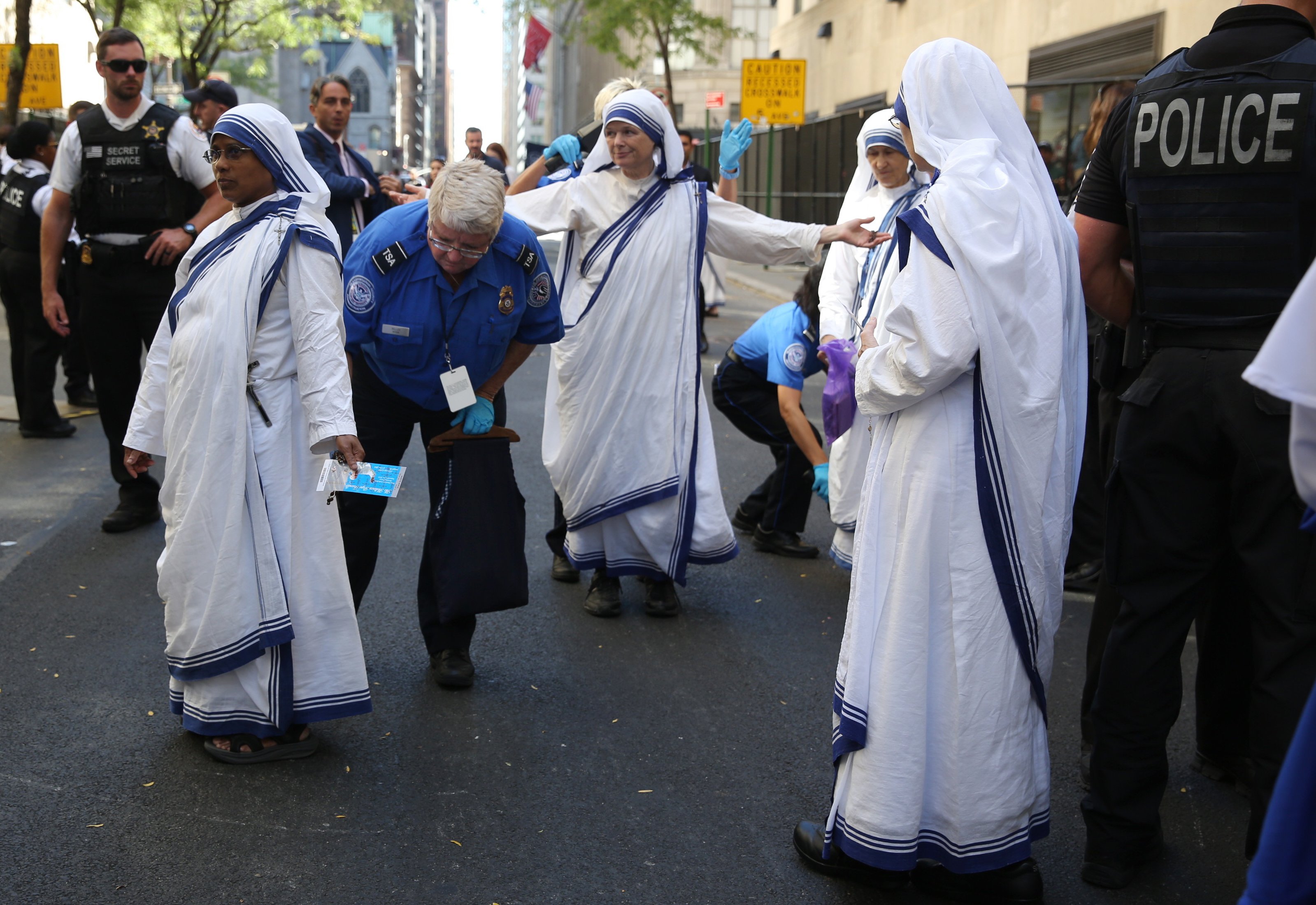 A New York City police officer searches nuns outside St. Patrick's Cathedral prior to the arrival of Pope Francis in New York, on Sept. 24, 2015.