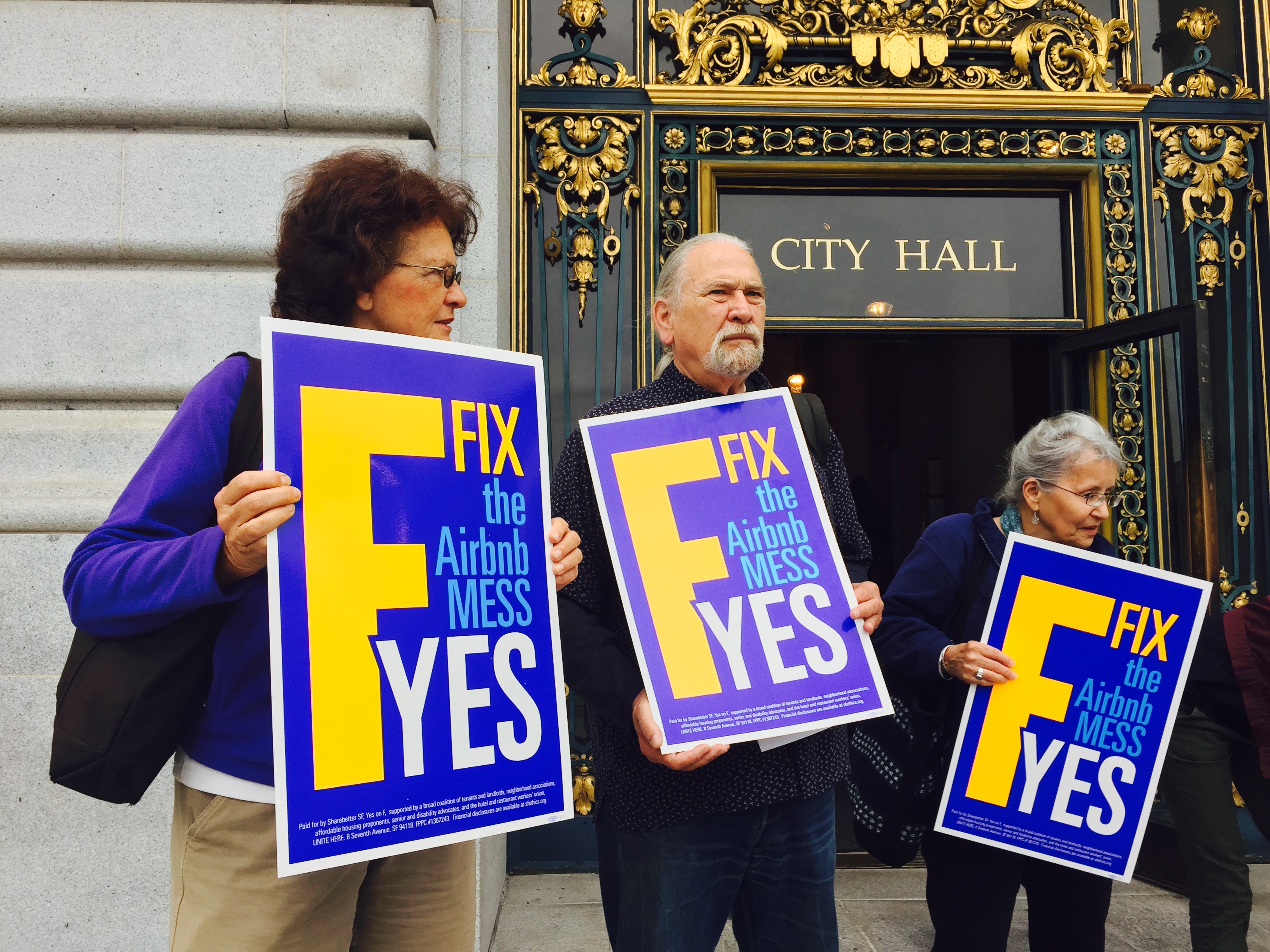 Supporters of a proposition that would place stricter limits on how often residents can rent out homes or rooms on Airbnb stand on the steps of San Francisco's city hall on Sept. 30, 2015. (Katy Steinmetz for TIME)