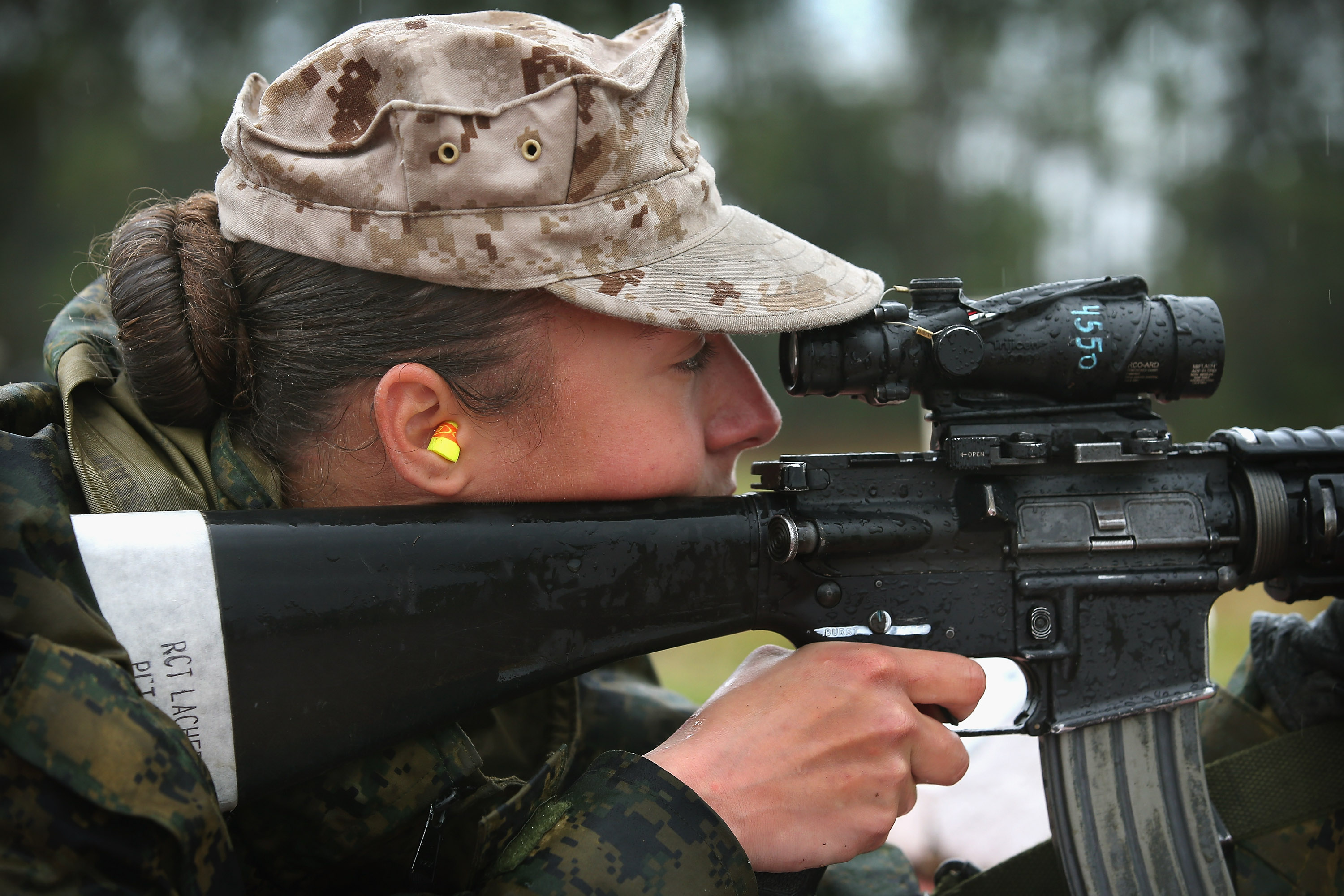 Marine recruit Cora Ann Lacher from Manuet, NY fires on the rifle range during boot camp on Feb. 25, 2013. (Scott Olson—Getty Images)