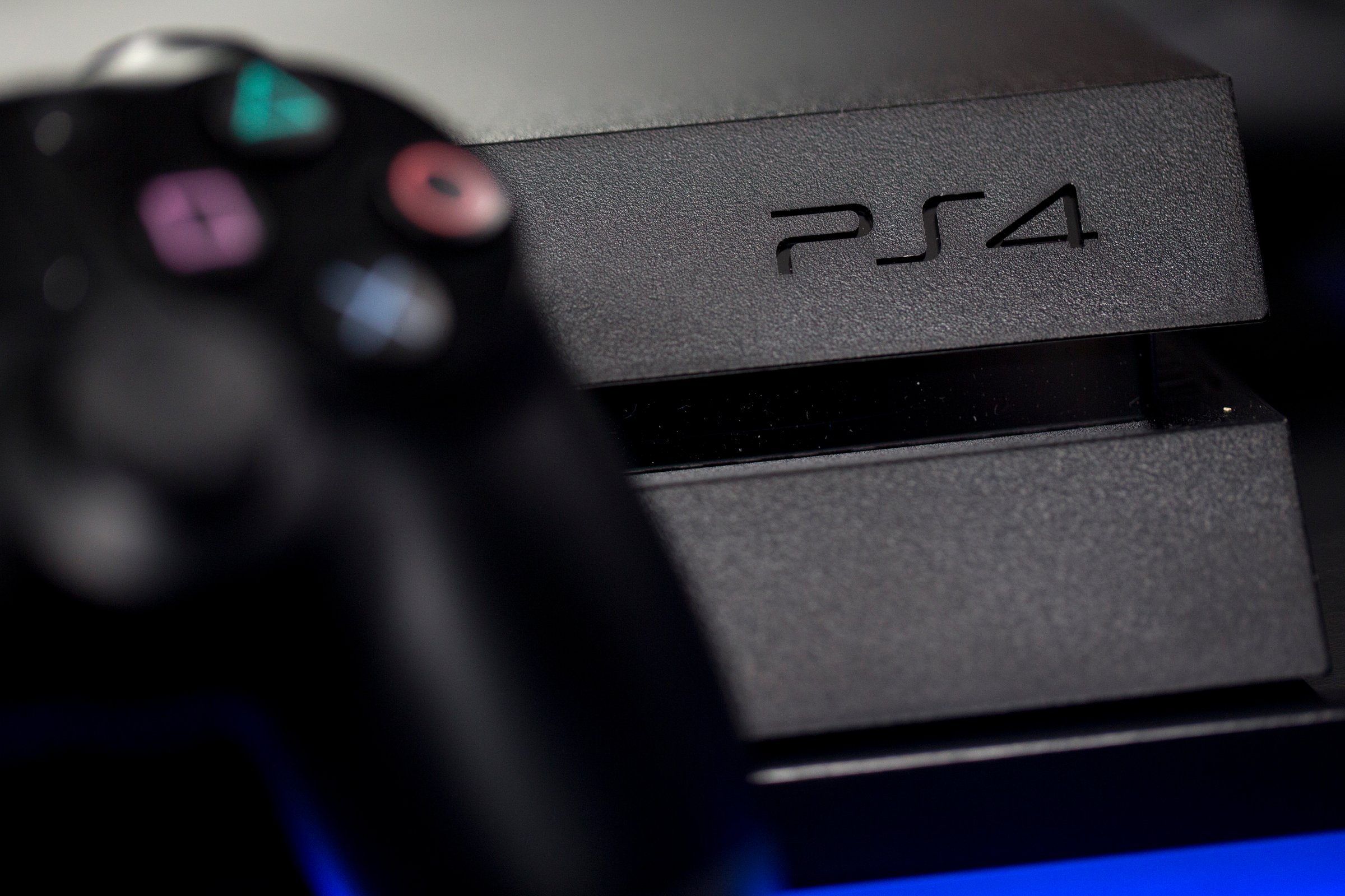 A logo sits on the front of a Sony PlayStation 4 (PS4) games console, manufactured by Sony Corp., in this arranged photograph taken in London on Nov. 15, 2013