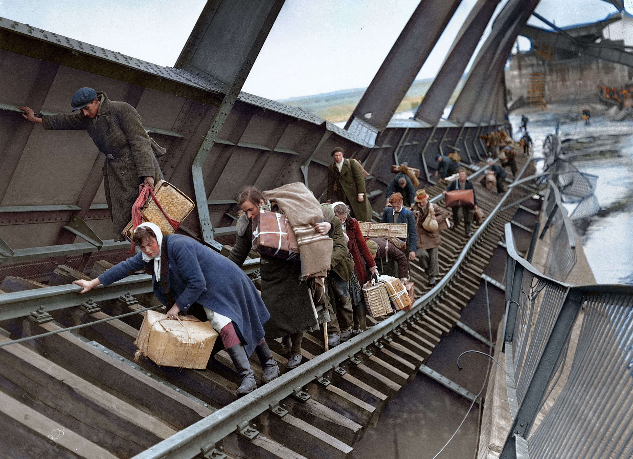 Displaced persons cross a bridge on the River Elbe at Tangermunde, which was blown up by the Germans, to escape the chaos behind German lines caused by the approach of the advancing Russians on May 1, 1945.