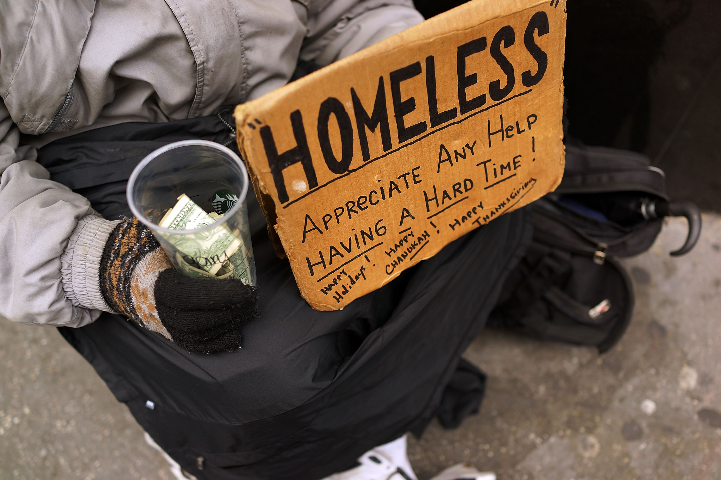 Panhandlers' Placards Show Signs Of Continued Economic Hardship