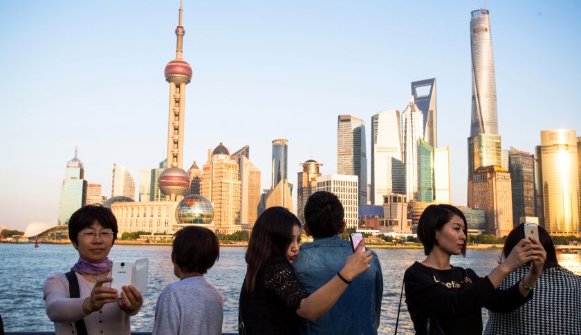 Tourists are taking selfies with the Oriental Pearl tower on
