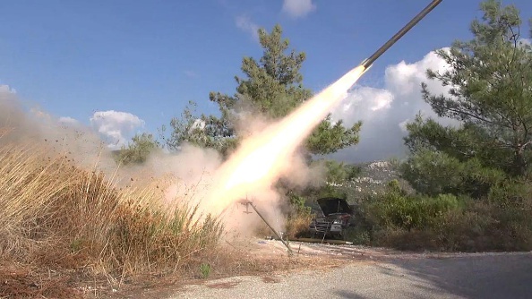 Syrian rebels fire a missile at the airbase being used by Russian aircraft at Lakatia Sept. 28. (Ali Hafawi / Anadolu Agency / Getty Images)
