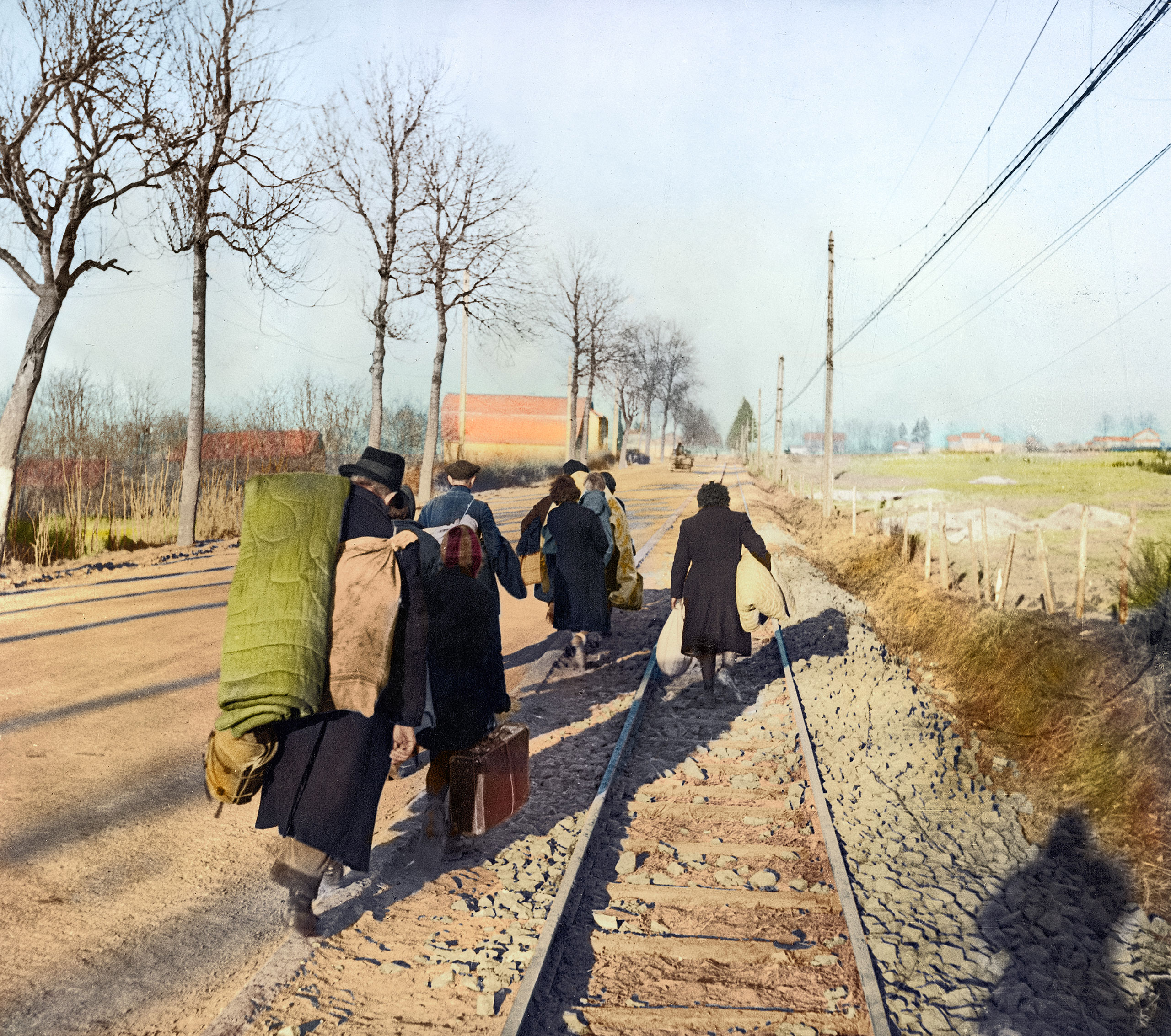 Belgian refugees carry their belongings with them as they flee from the advancing German army in January 1945.