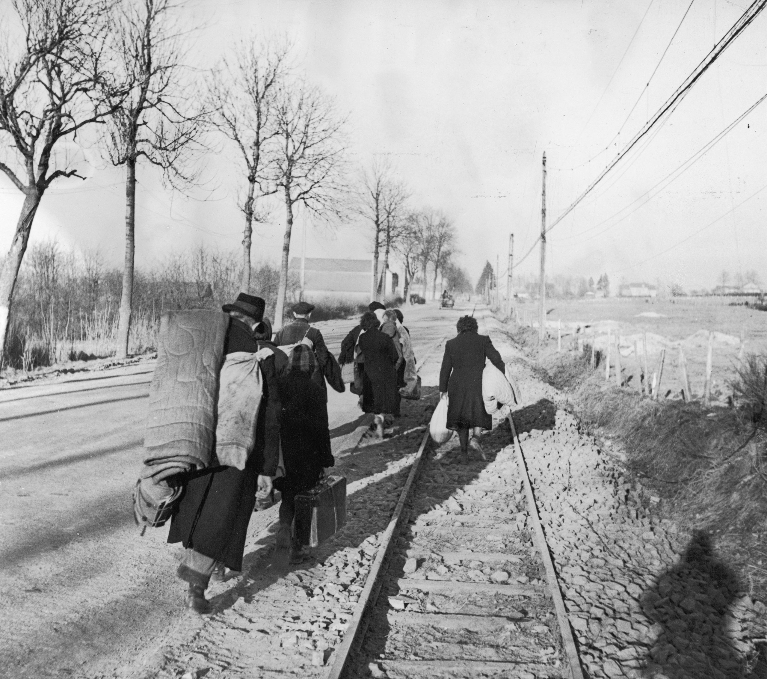 Belgian refugees carry their belongings with them as they flee from the advancing German army in January 1945.