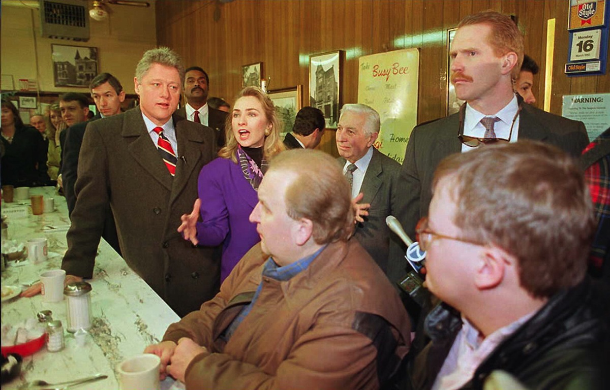 Democratic presidential candidate Bill Clinton (L) and his wife Hillary (C) refute allegations at the Busy Bee Cafe in Chicago that she has profited from Arkansas' state fund, in a picture taken Mar. 16, 1992. (Tom Holoubek—AFP/Getty Images)