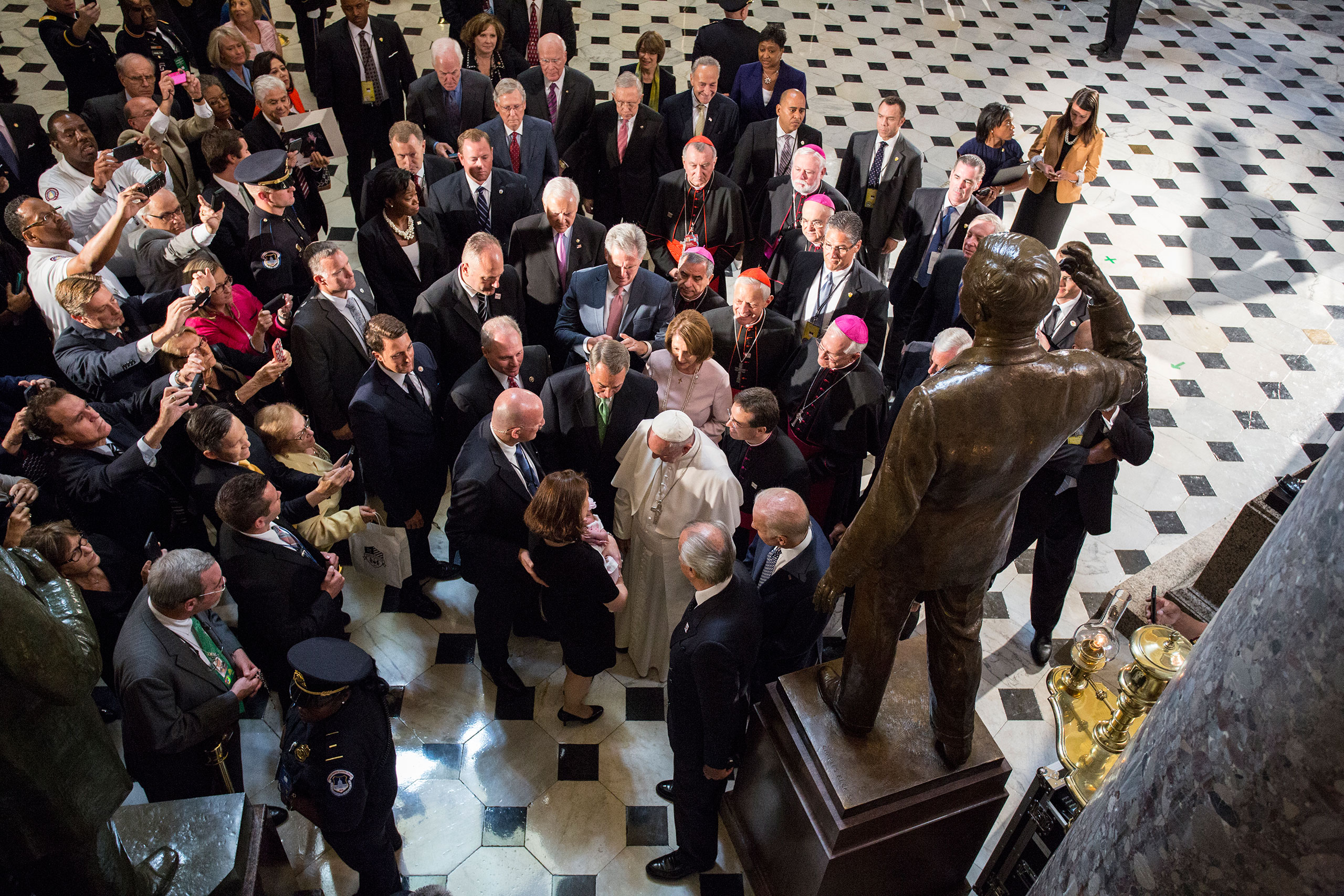 Pope Francis blesses an unidentified child in Statuary Hall at the U.S. Capitol in Washington, D.C. Sept, 24, 2015.From  Photographing the Pope From a Different Vantage Point