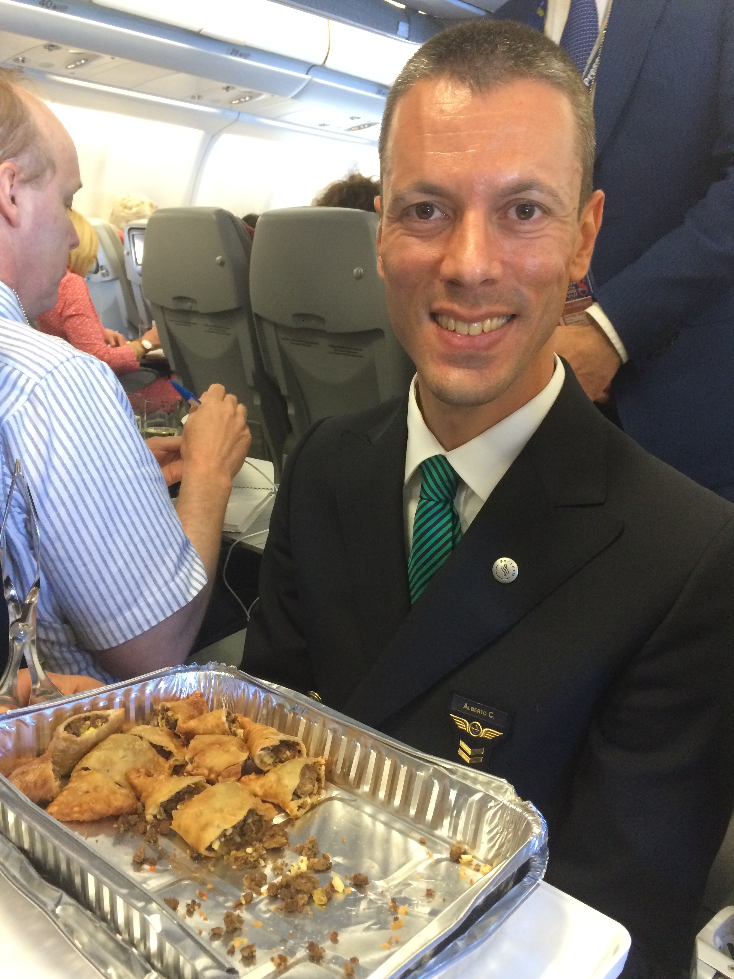 Alitalia flight attendant serves the empanadas that were a gift to Pope Francis to journalists aboard the papal flight from Rome to Havana. (Elizabeth Dias, Sept 19, 2015)