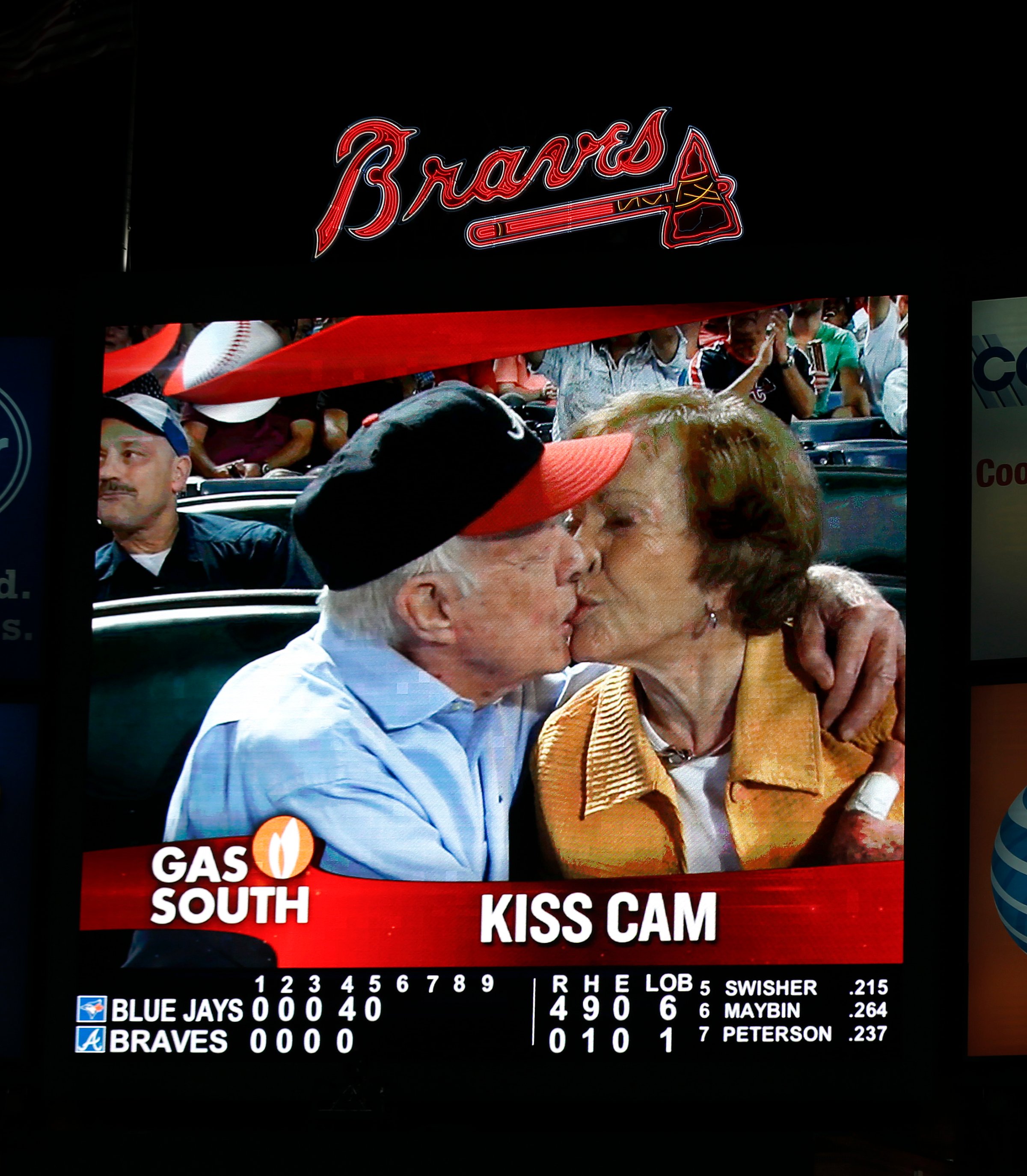 Jimmy Carter kisses his wife, Rosalynn, on the "Kiss Cam" during a baseball game between the Atlanta Braves and the Toronto Blue Jays in Atlanta on Sept. 17, 2015.