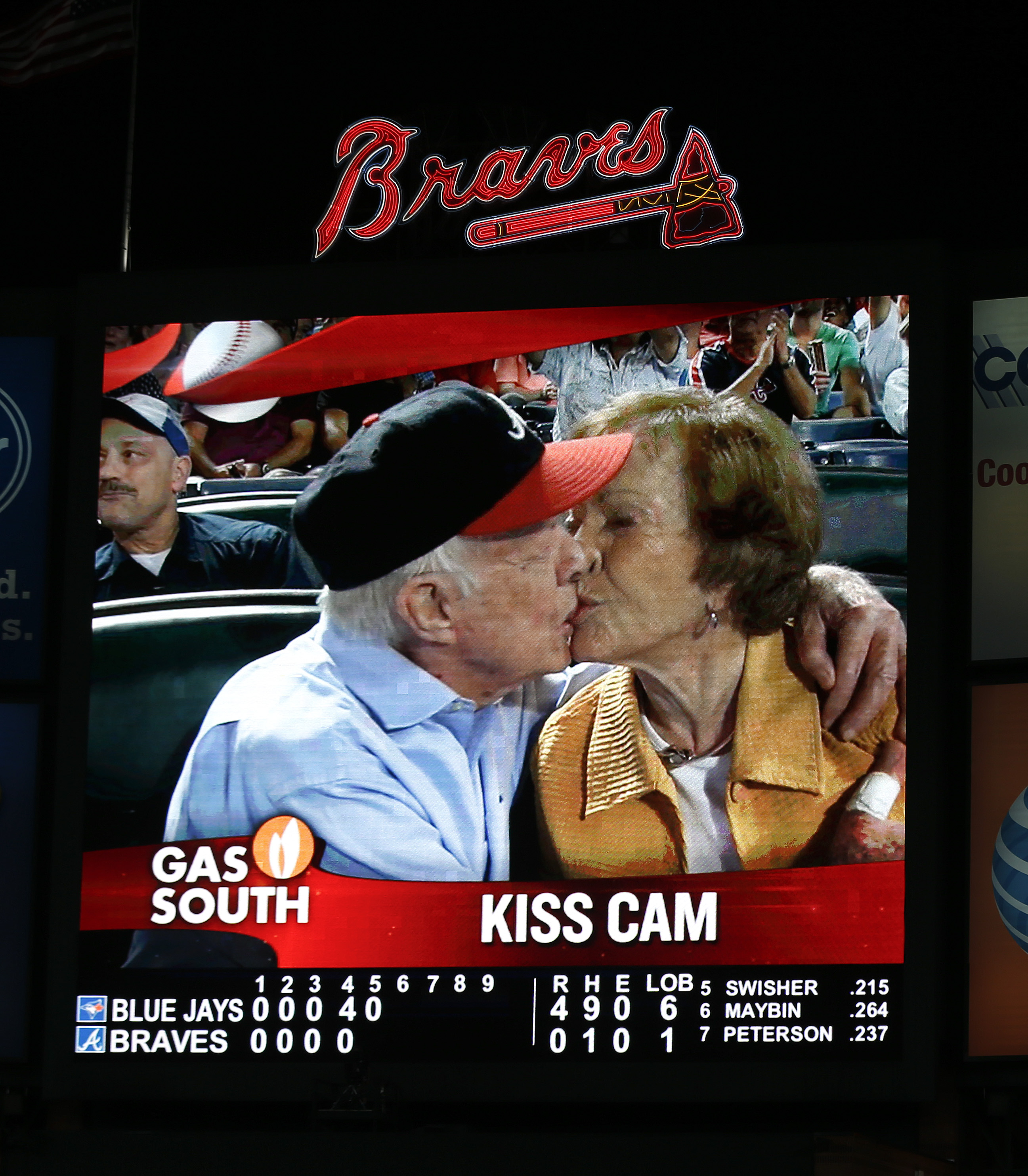 Jimmy Carter kisses his wife, Rosalynn, on the "Kiss Cam" during a baseball game between the Atlanta Braves and the Toronto Blue Jays in Atlanta on Sept. 17, 2015.
