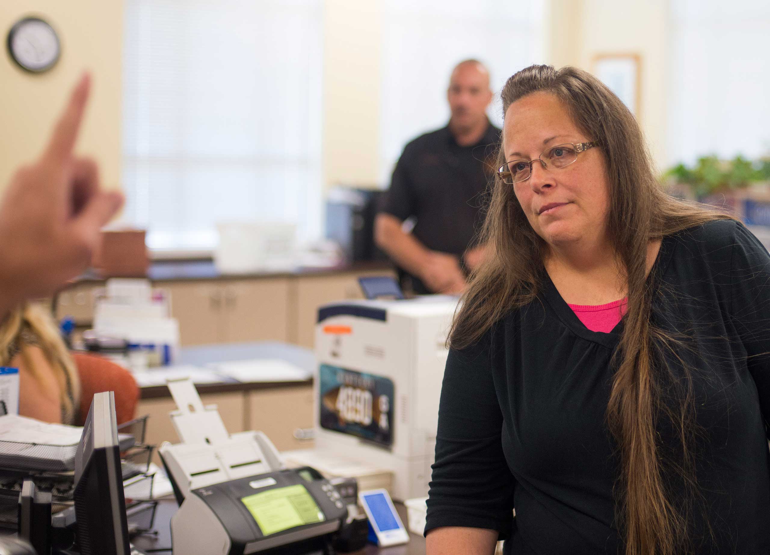 Kim Davis, the Rowan County Clerk of Courts, listens to Robbie Blankenship and Jesse Cruz as they speak with her about getting a marriage license at the County Clerks Office on Sept. 2, 2015 in Morehead, Ky. (Ty Wright—Getty Images)