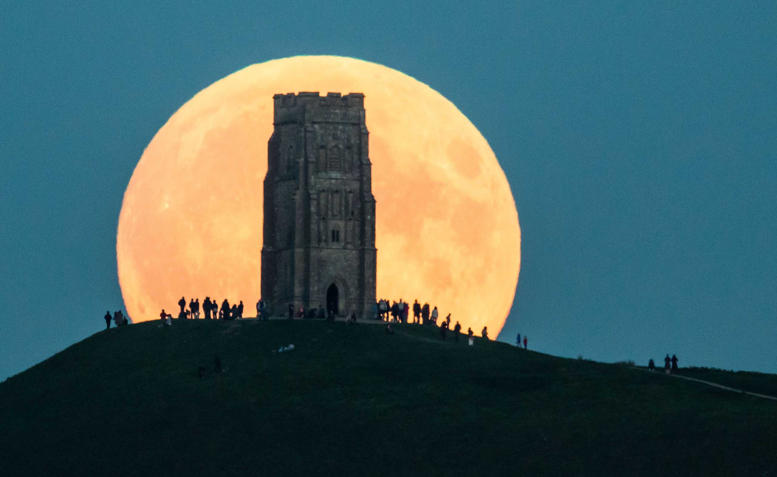 The supermoon rises behind Glastonbury Tor in Glastonbury, England, on Sept. 27, 2015 (Matt Cardy—Getty Images)
