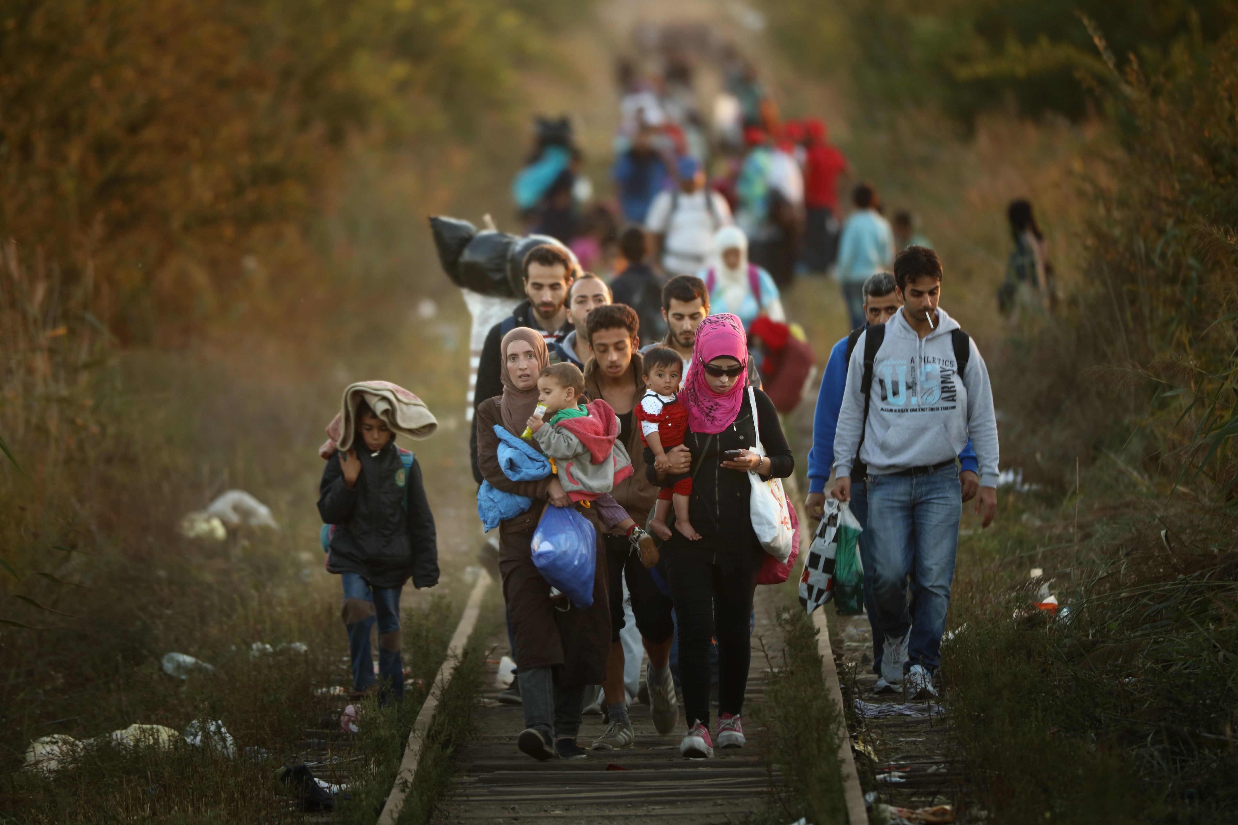 Migrants make their way through Serbia, near the town of Subotica, towards a break in the steel and razor fence erected on the  border by the Hungarian government on Sept. 9, 2015 in Subotica, Serbia. (Christopher Furlong— Getty Images)