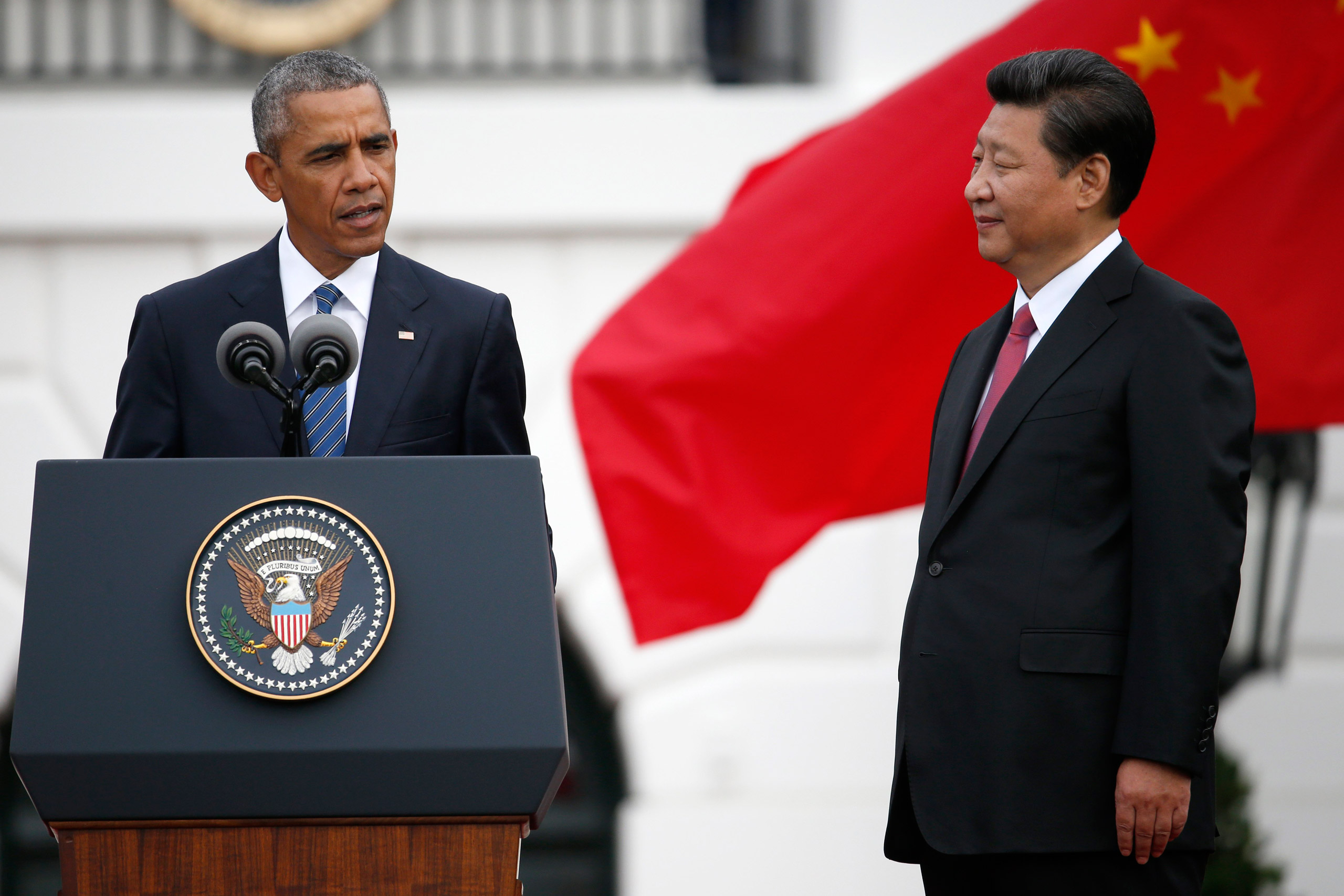 Chinese President Xi Jinping listens as President Barack Obama speaks during an official state arrival ceremony for the Chinese president, Friday, Sept. 25, 2015, on the South Lawn of the White House in Washington. (AP Photo/Evan Vucci)