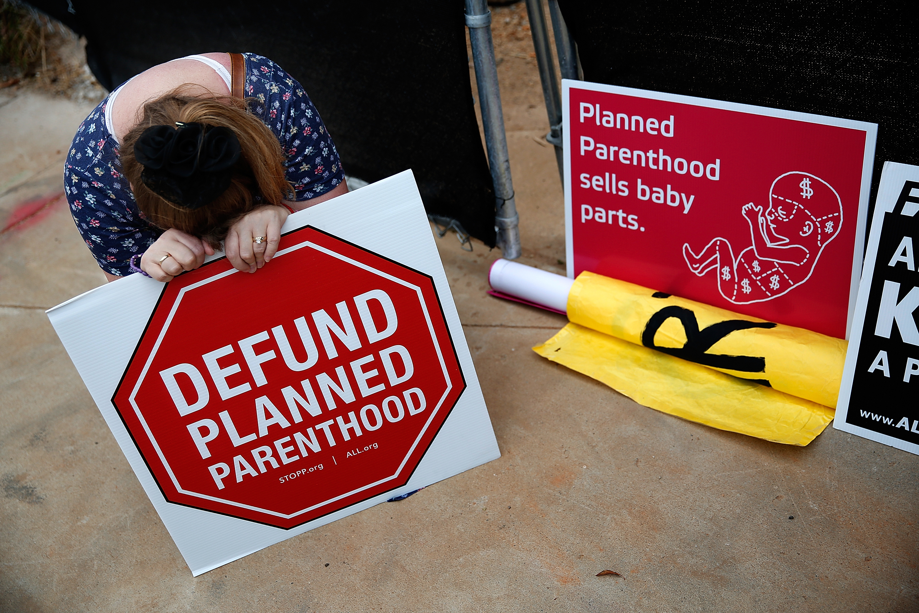 Right to Life advocate Linda Heilman prays during a sit-in in front of a proposed Planned Parenthood location while demonstrating the group's opposition to congressional funding of Planned Parenthood in Washington, DC, on Sept. 21, 2015.