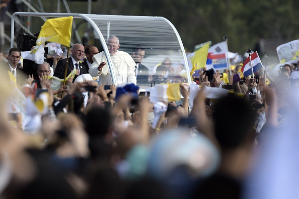Pope Francis waves as he arrives in the popemobile to deliver a mass at Nu Guazu field in the outskirts of Asuncion, Paraguay on July 12, 2015.