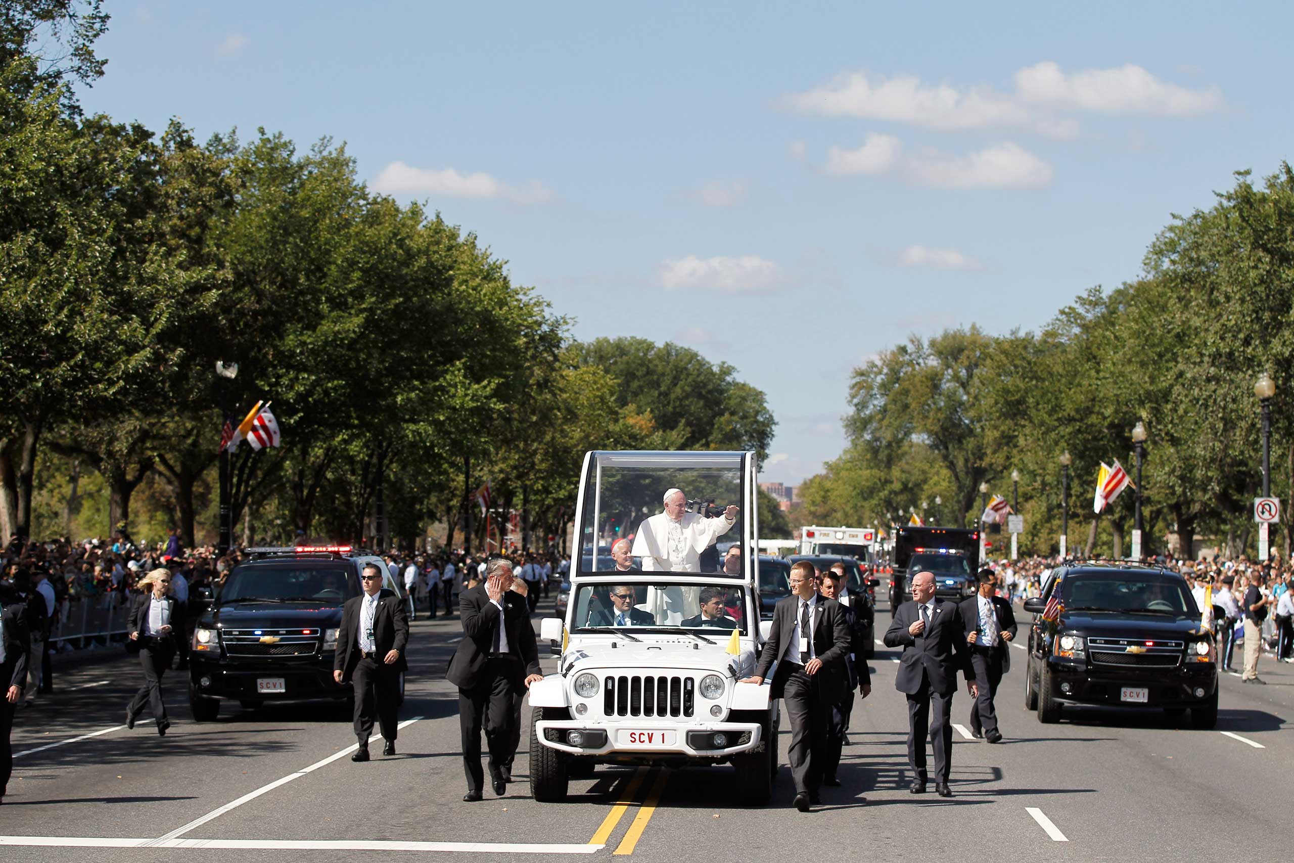 Pope Francis waves to the crowd from the popemobile during a parade along Constitution Avenue in Washington, on Sept. 23, 2015.