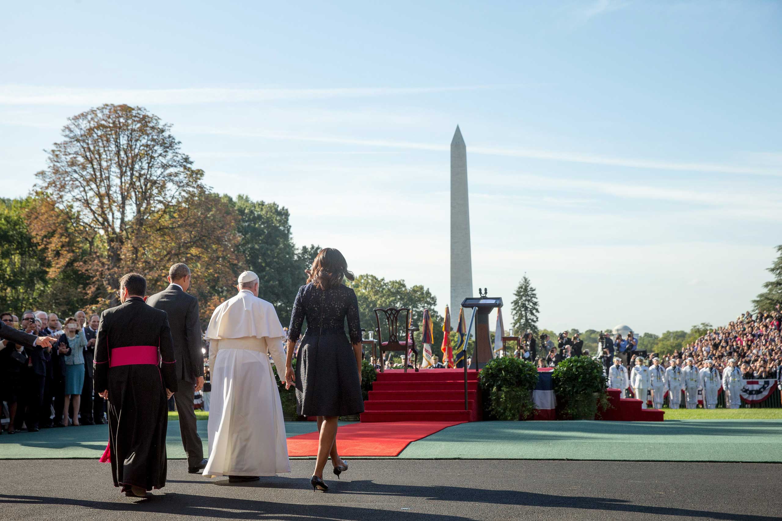 President Barack Obama and first lady Michelle Obama accompany Pope Francis to the stage during a state arrival ceremony, on Sept. 23, 2015, on the South Lawn of the White House in Washington.