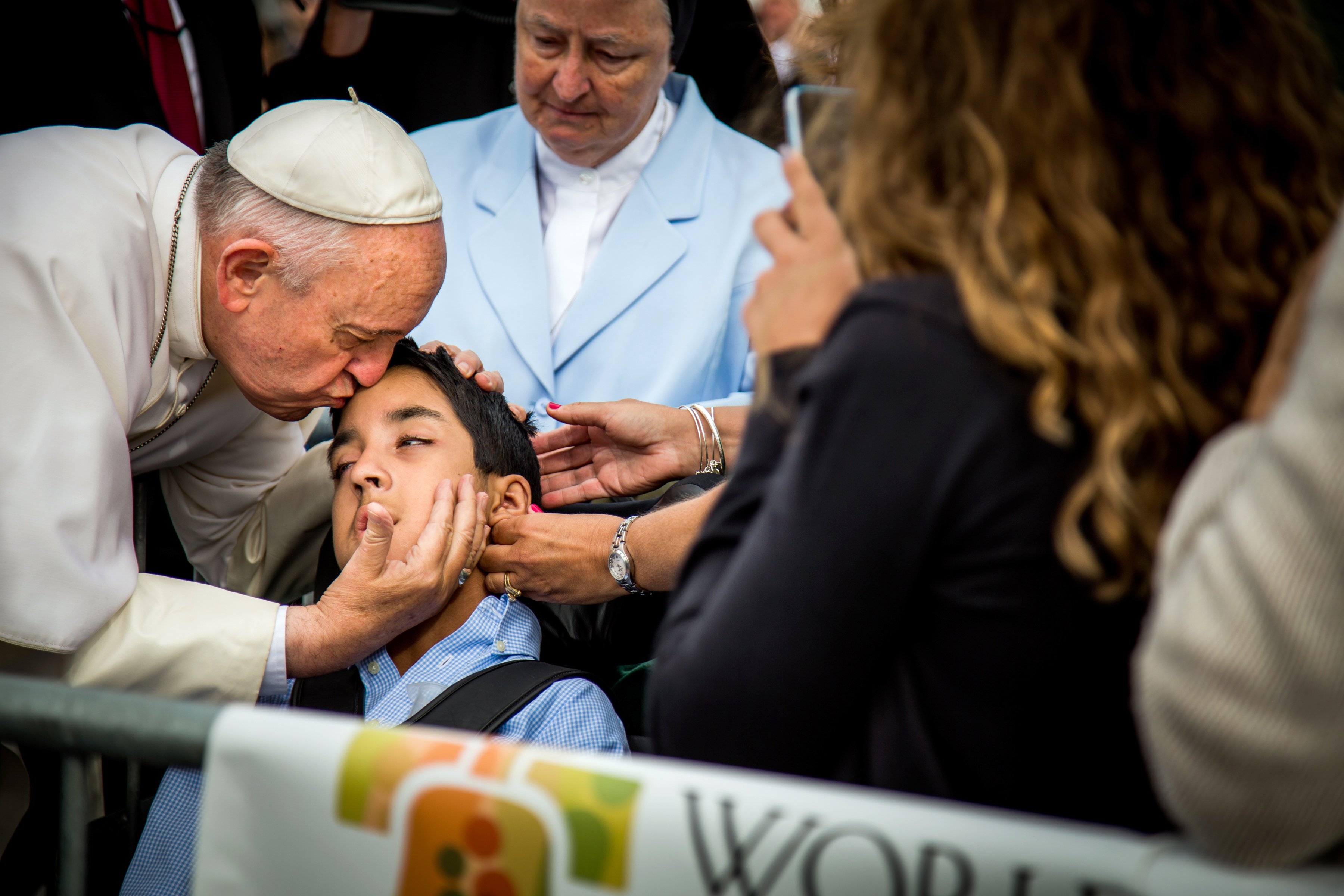 Pope Francis kisses and blesses Michael Keating, 10, of Elverson, Pa after arriving in Philadelphia and exiting his car when he saw the boy, Saturday, Sept. 26, 2015, at Philadelphia International Airport.