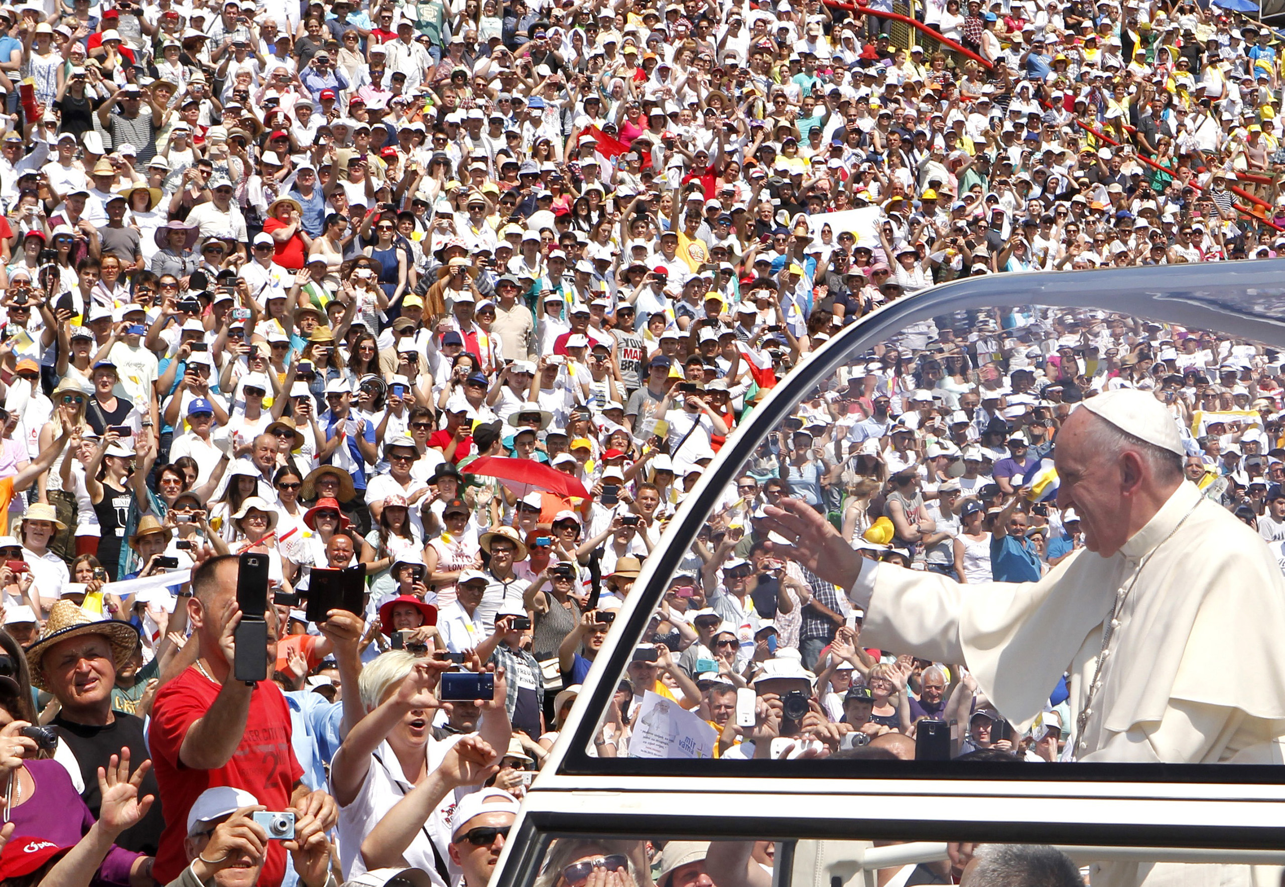 Pope Francis waves to the crowd as he arrives in Bosnia and Herzegovina for a Mass in 2015. (Amel Emric—AP)