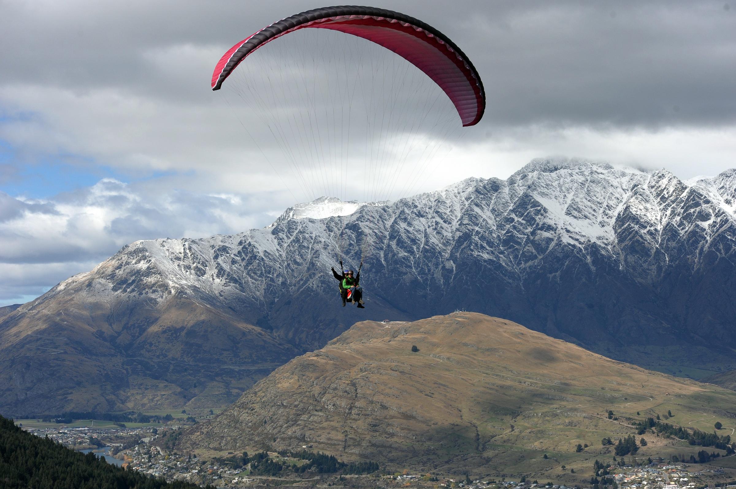 People paraglide from Ben Lomond mountai