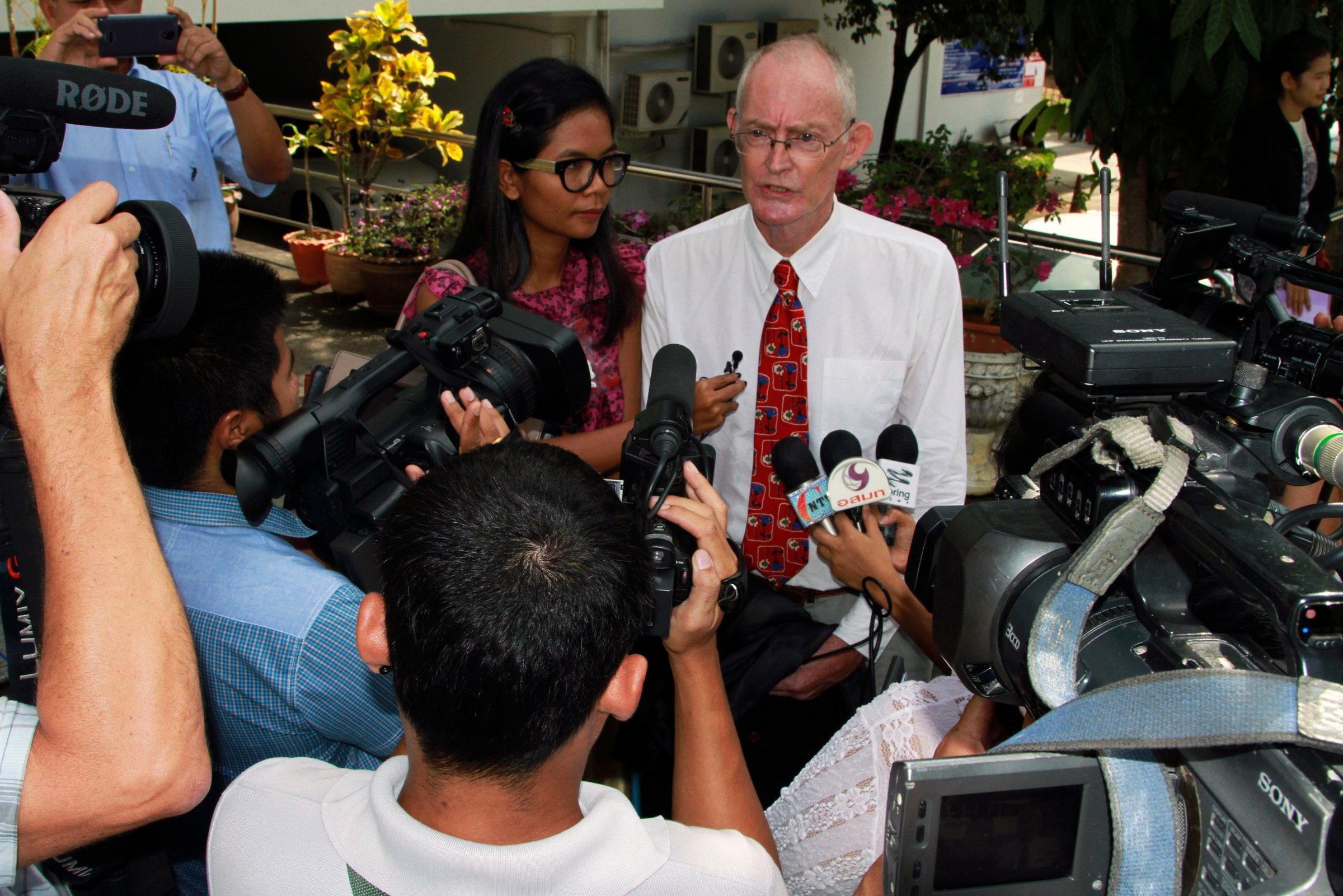Morison and Sidasathian, reporters for the Phuketwan news website, speak to media as they arrive to a criminal court in Phuket
