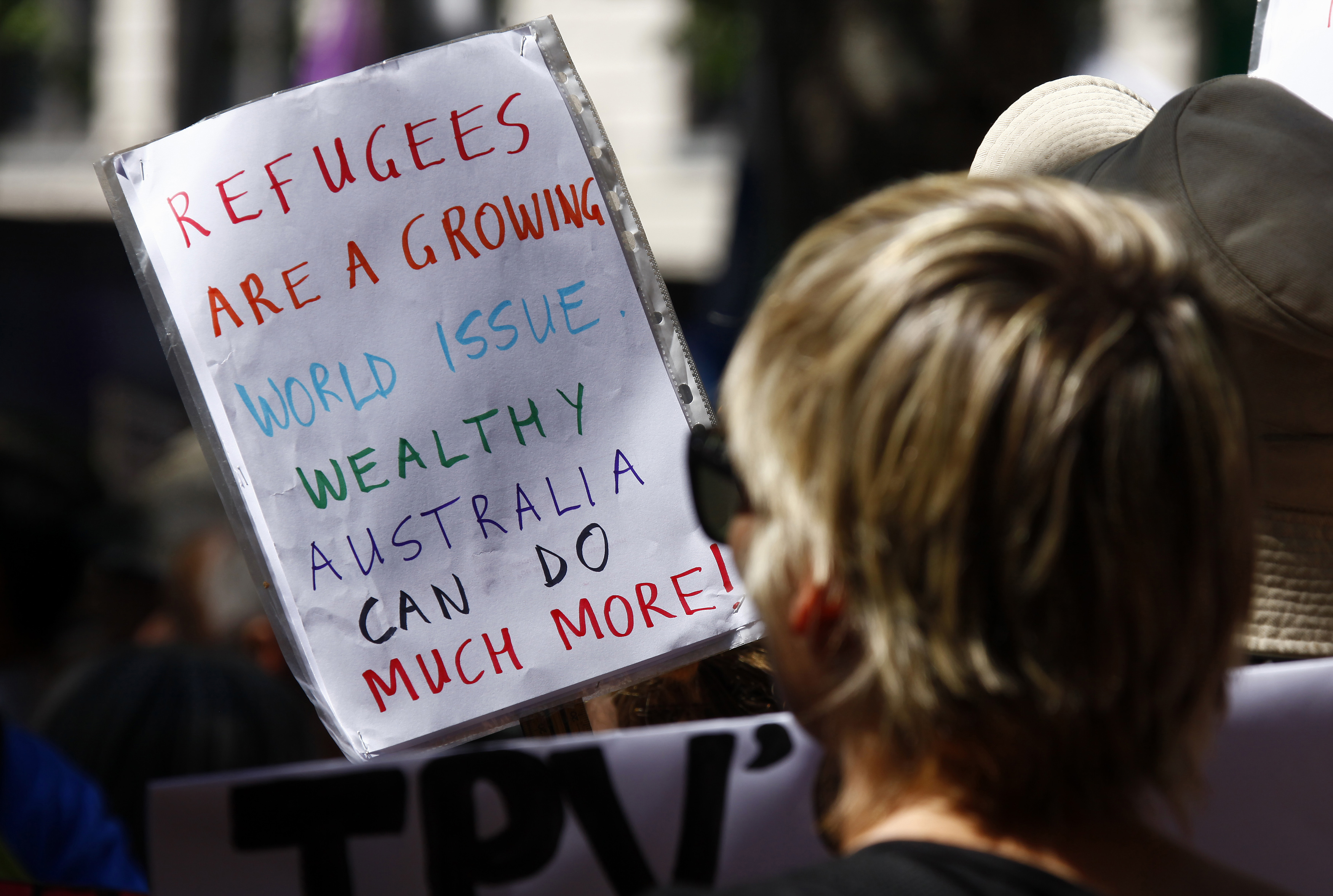 Protesters hold placards at the Stand up for Refugees rally held in central Sydney on Oct. 11, 2014 (David Gray—Reuters)