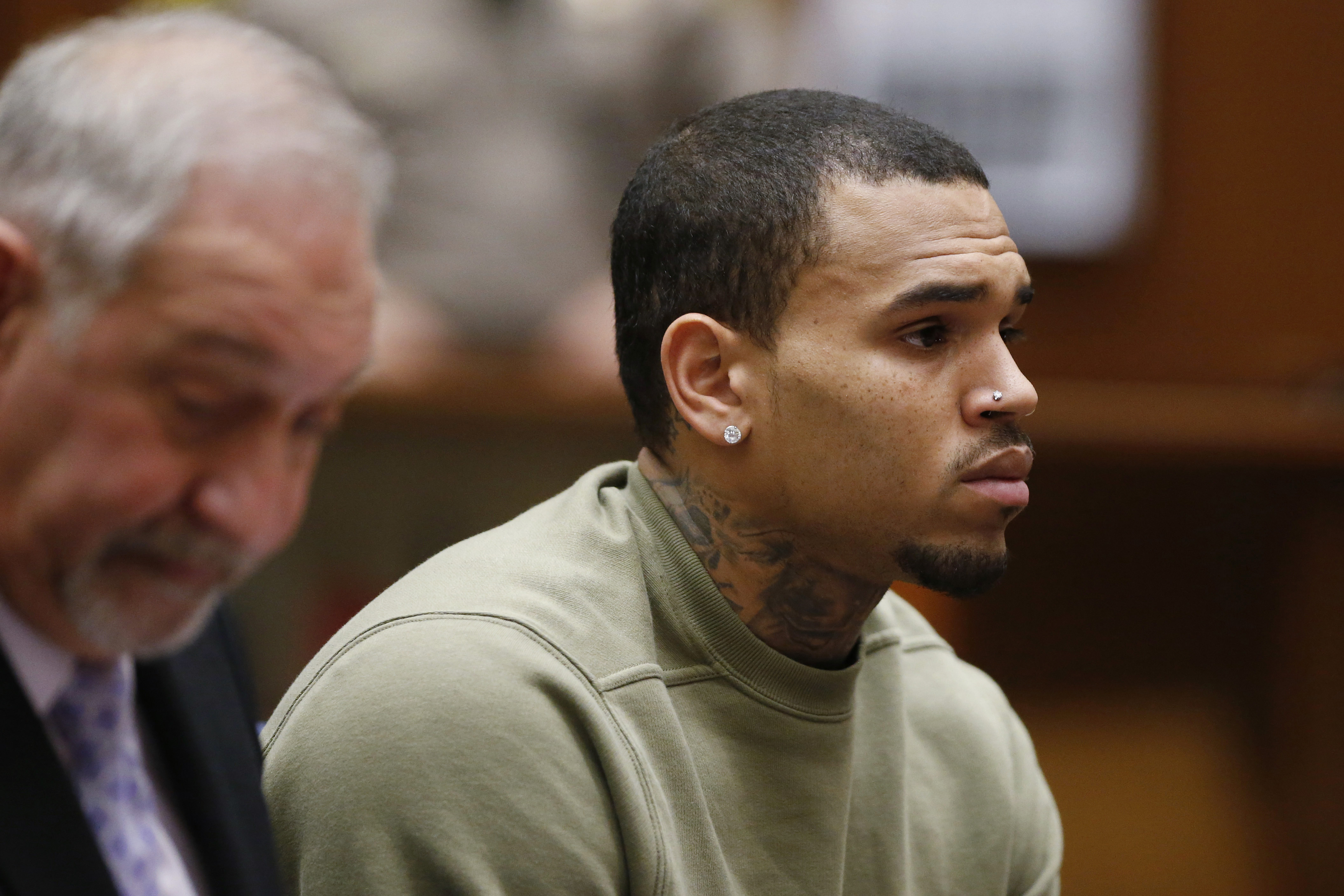Singer Chris Brown (R), who pleaded guilty to assaulting his girlfriend Rihanna, appears in court with his lawyer Mark Geragos for a progress hearing, in Los Angeles, California, January 15, 2015. (Lucy Nicholson—Reuters)