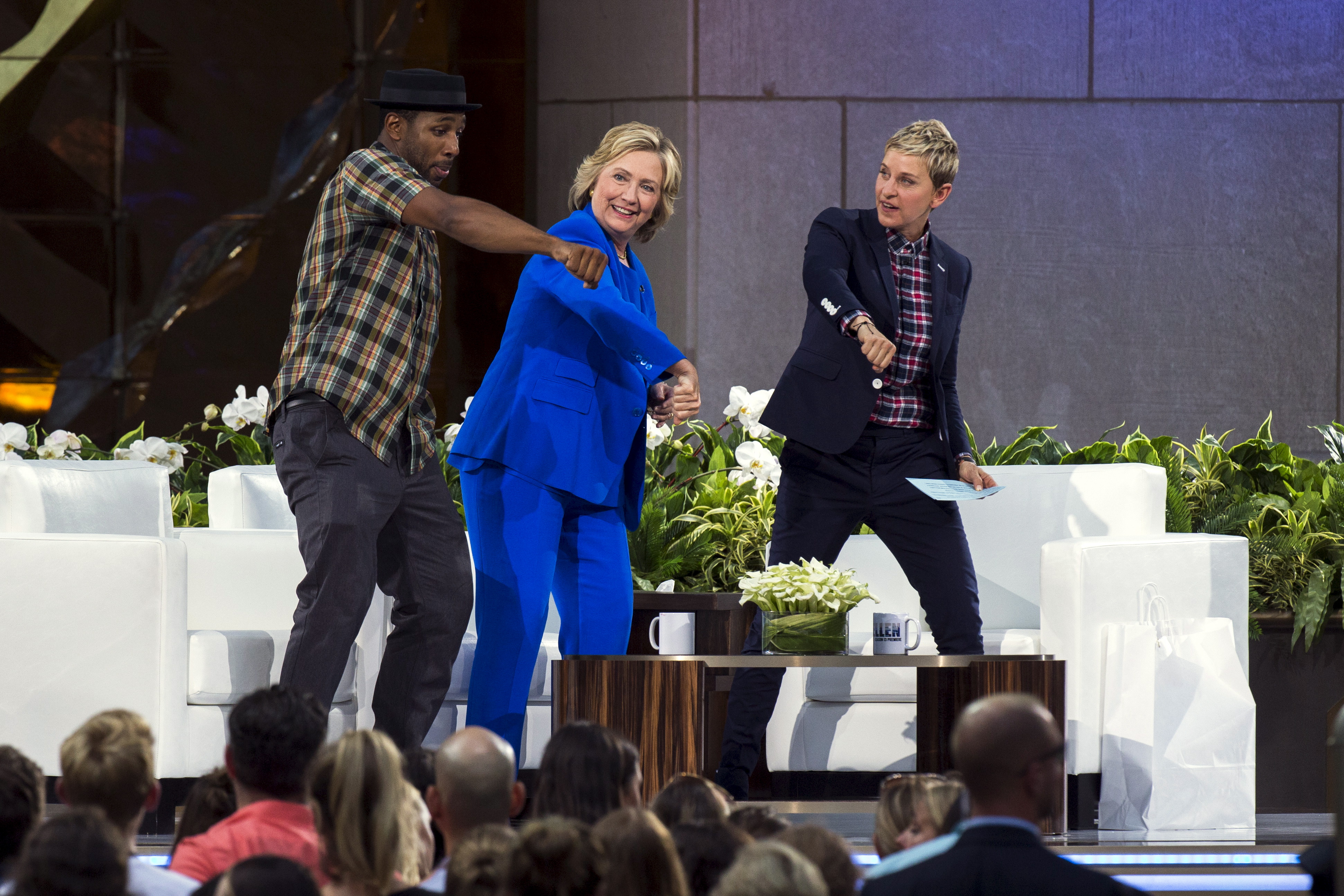 Hillary Clinton dances with DJ "Twitch" and Ellen DeGeneres during a taping of "The Ellen DeGeneres Show" in New York