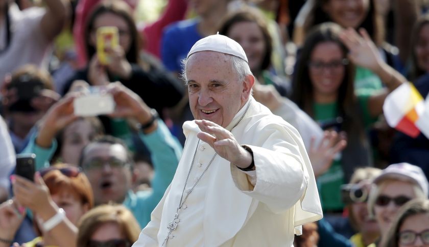 Pope Francis waves as he arrives to lead his Wednesday general audience in Saint Peter's Square at the Vatican