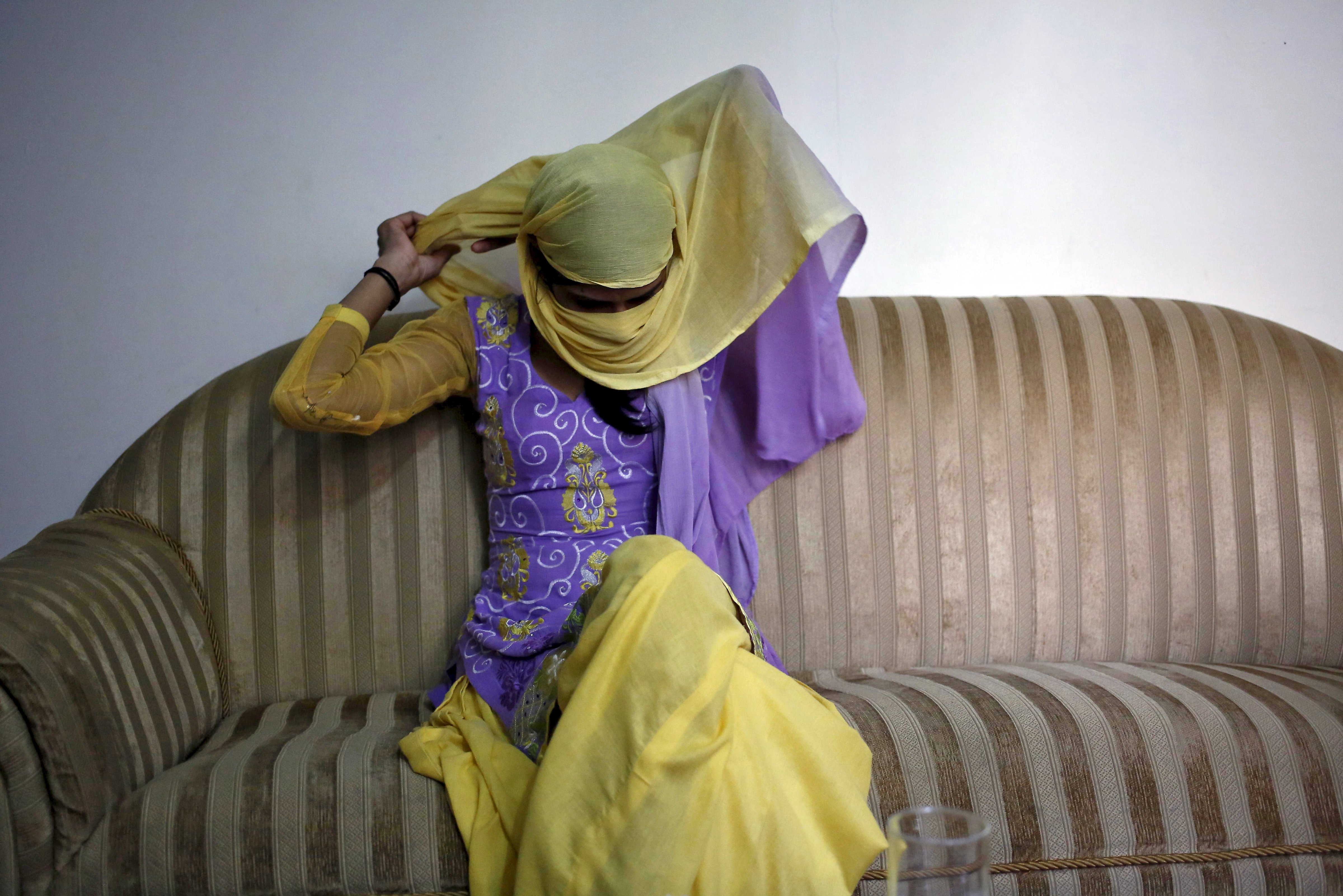 Meenakshi Kumari, 23, one of the two sisters allegedly threatened with rape by a village council in the northern Indian state of Uttar Pradesh, adjusts her headgear as she sits inside her lawyer's chamber in New Delhi on Sept. 1, 2015 (Anindito Mukherjee—Reuters)