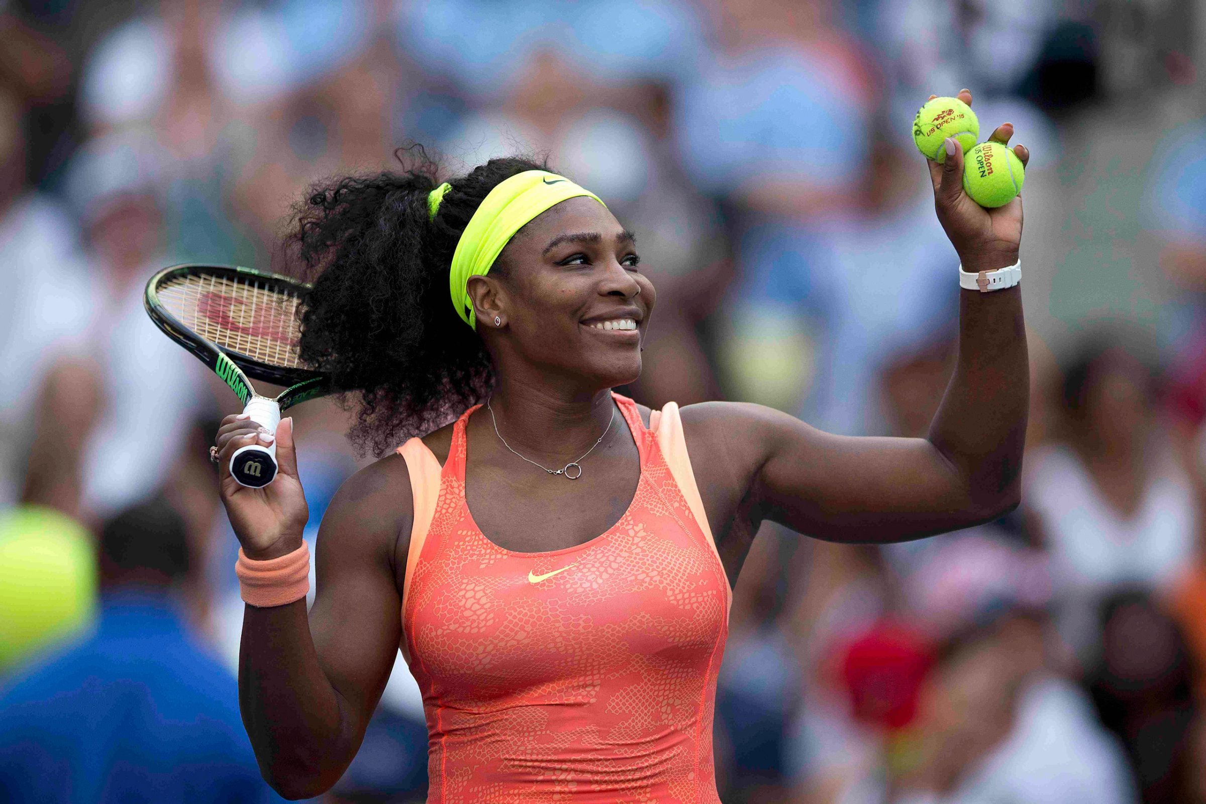 Serena Williams of the U.S. hits tennis balls to the fans after defeating compatriot Madison Keys in their fourth round match at the U.S. Open Championships tennis tournament in New York, September 6, 2015. REUTERS/Carlo Allegri